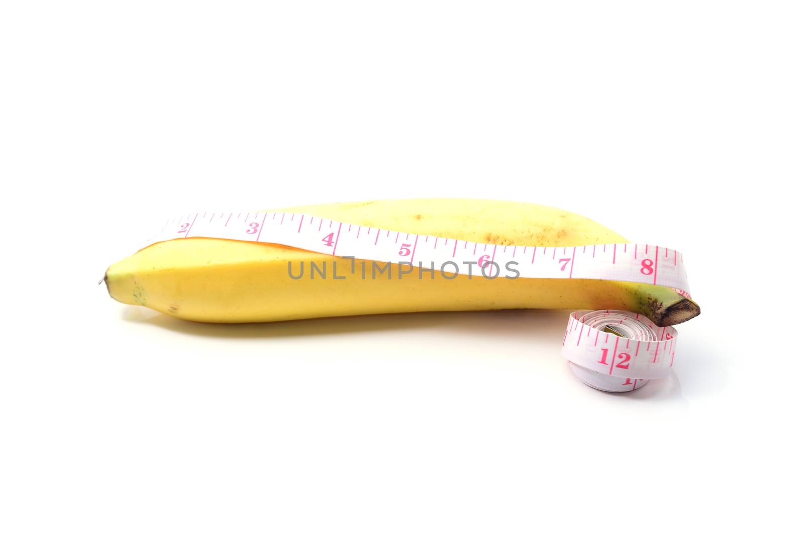 banana with measurement tape men penis size concept on white by ipuwadol