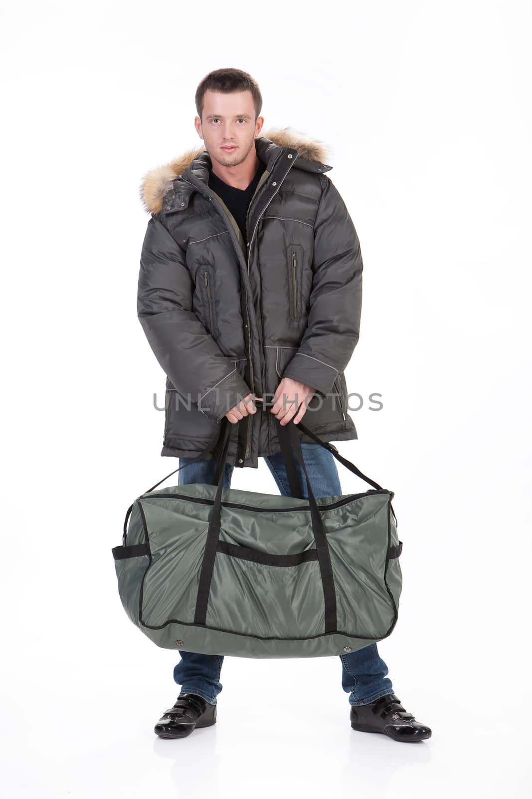 Young man in winter clothing on an isolated studio background