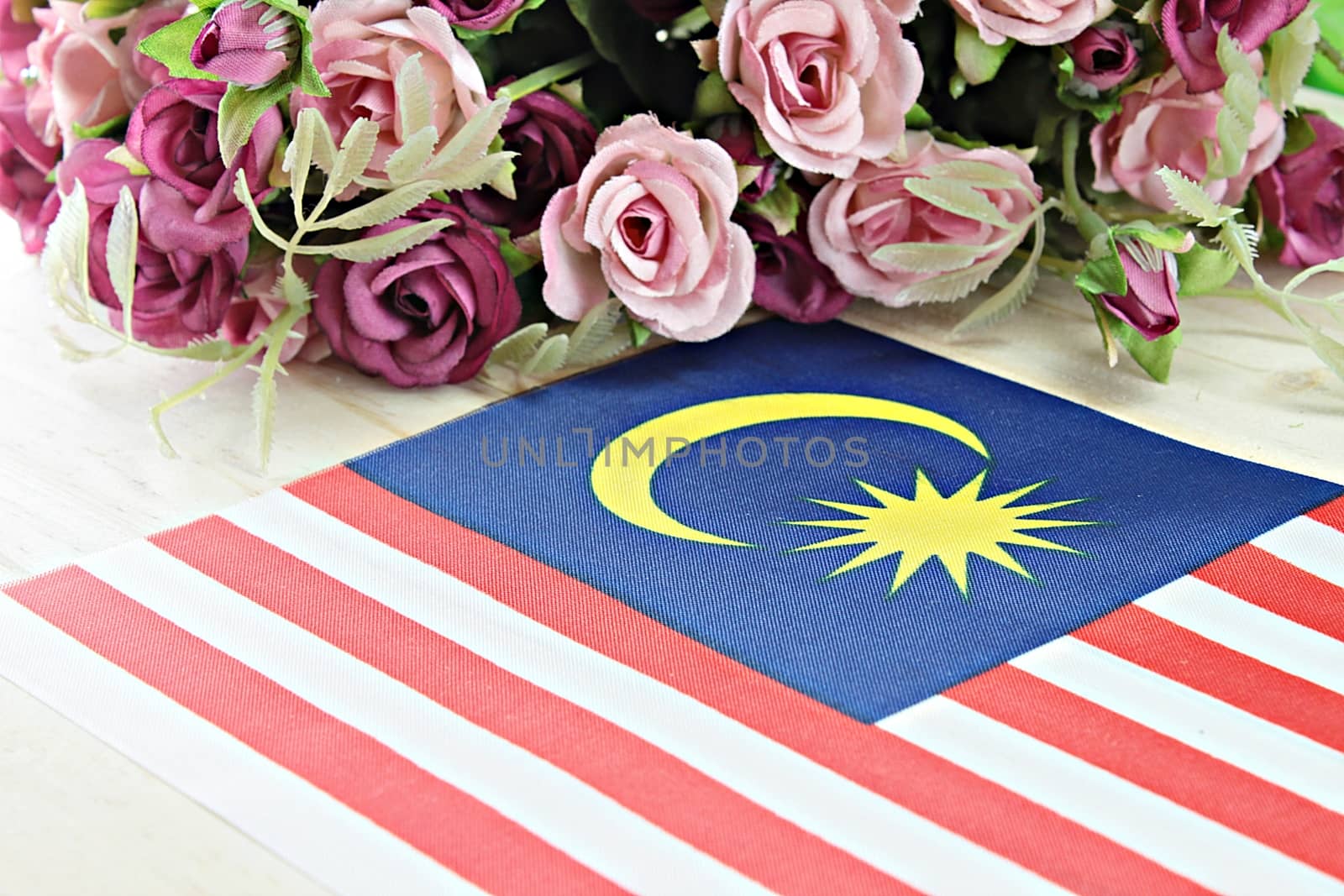 National day : Malaysia flag and flower on wood background