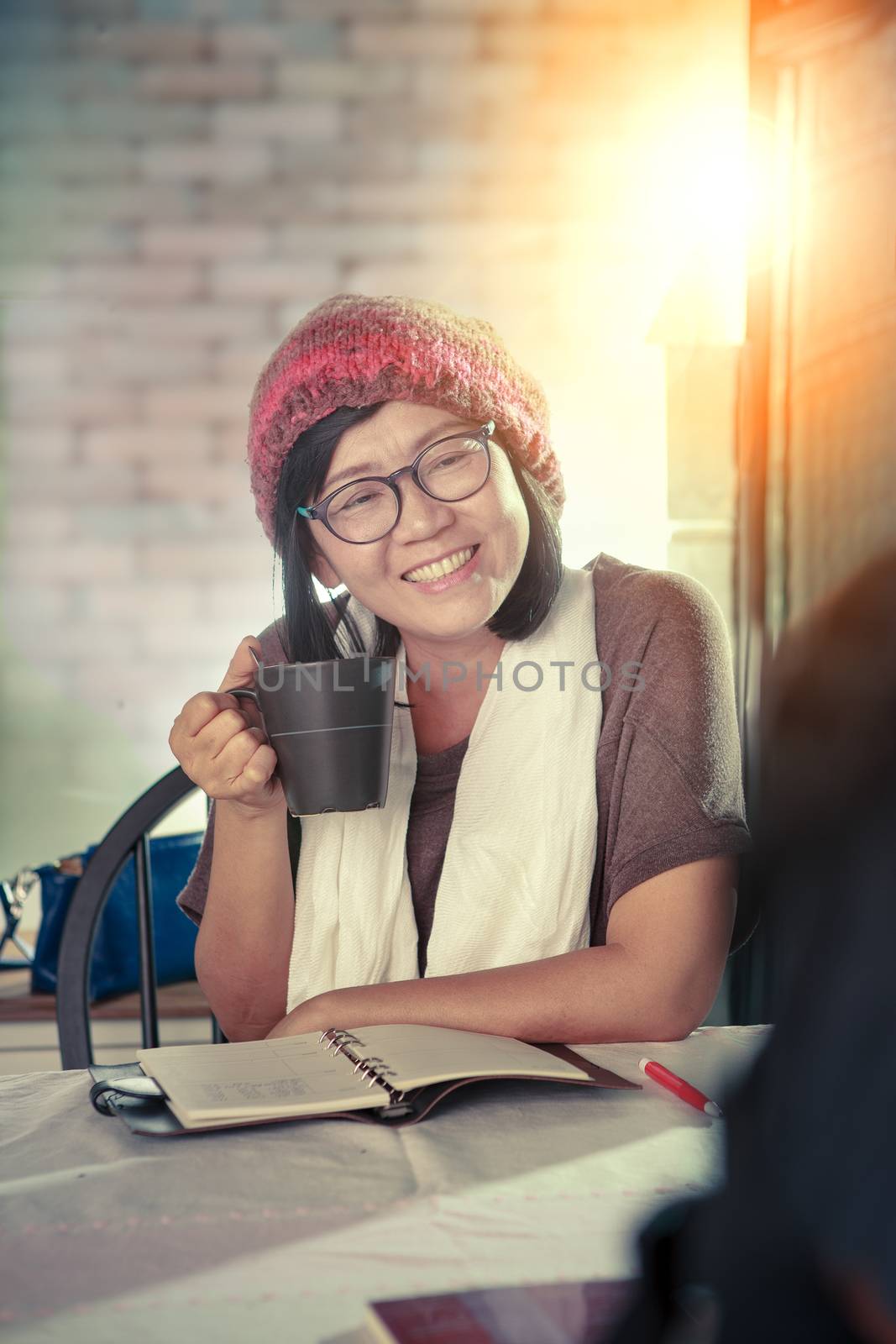 asian woman toothy smiling face with happiness emotion discussion in cofee shop ,relaxing emotion ,modern lifestyle of people