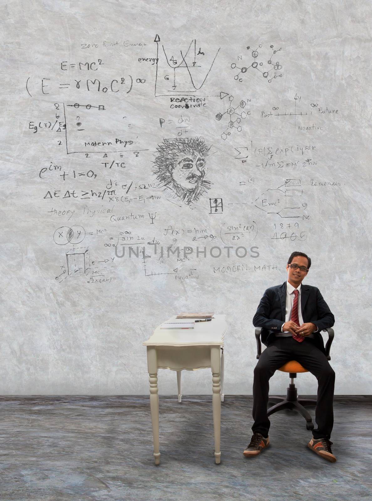 man sitting on desk and physic formula on wall by khunaspix