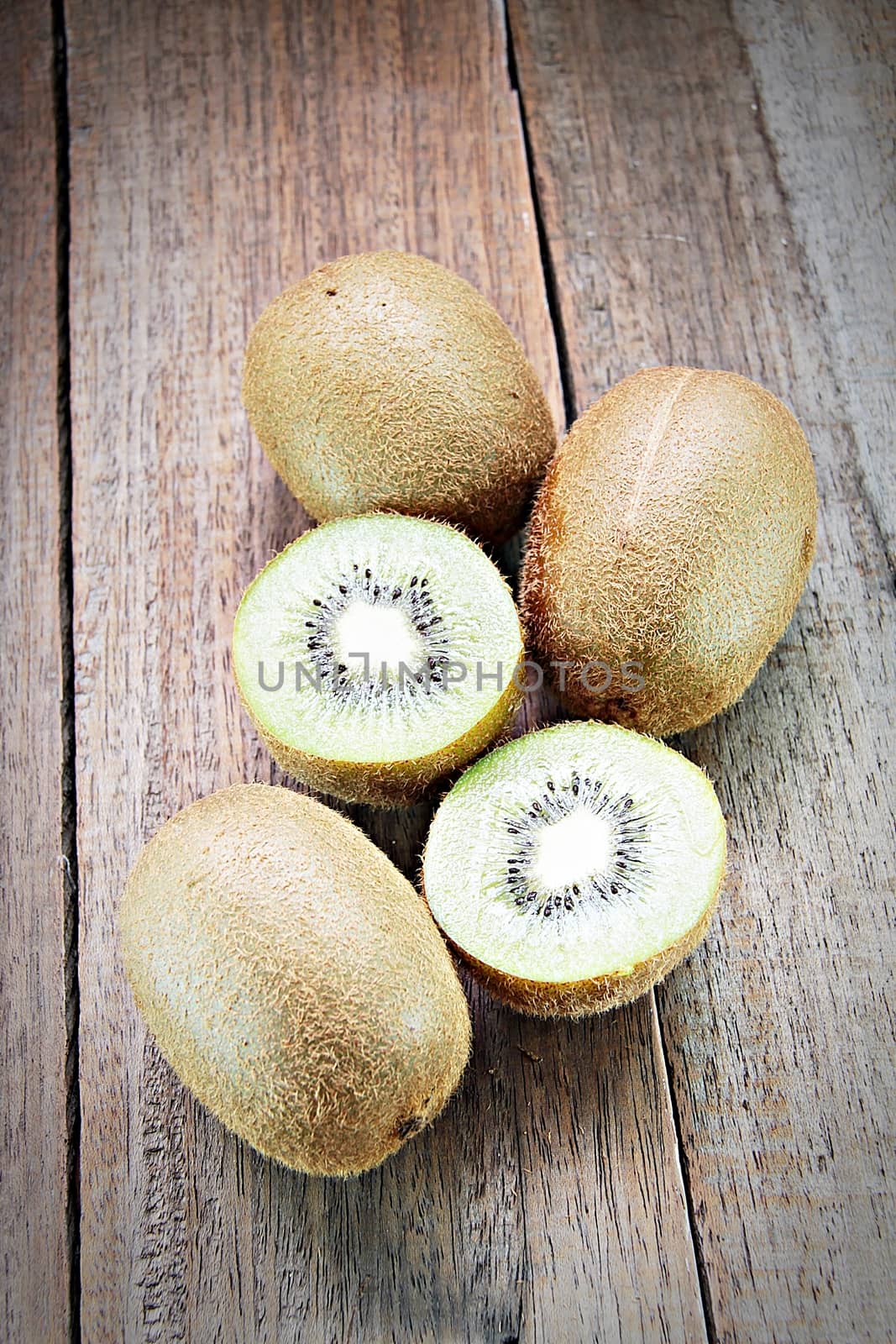 Fresh kiwi fruits on wooden background, selective focus