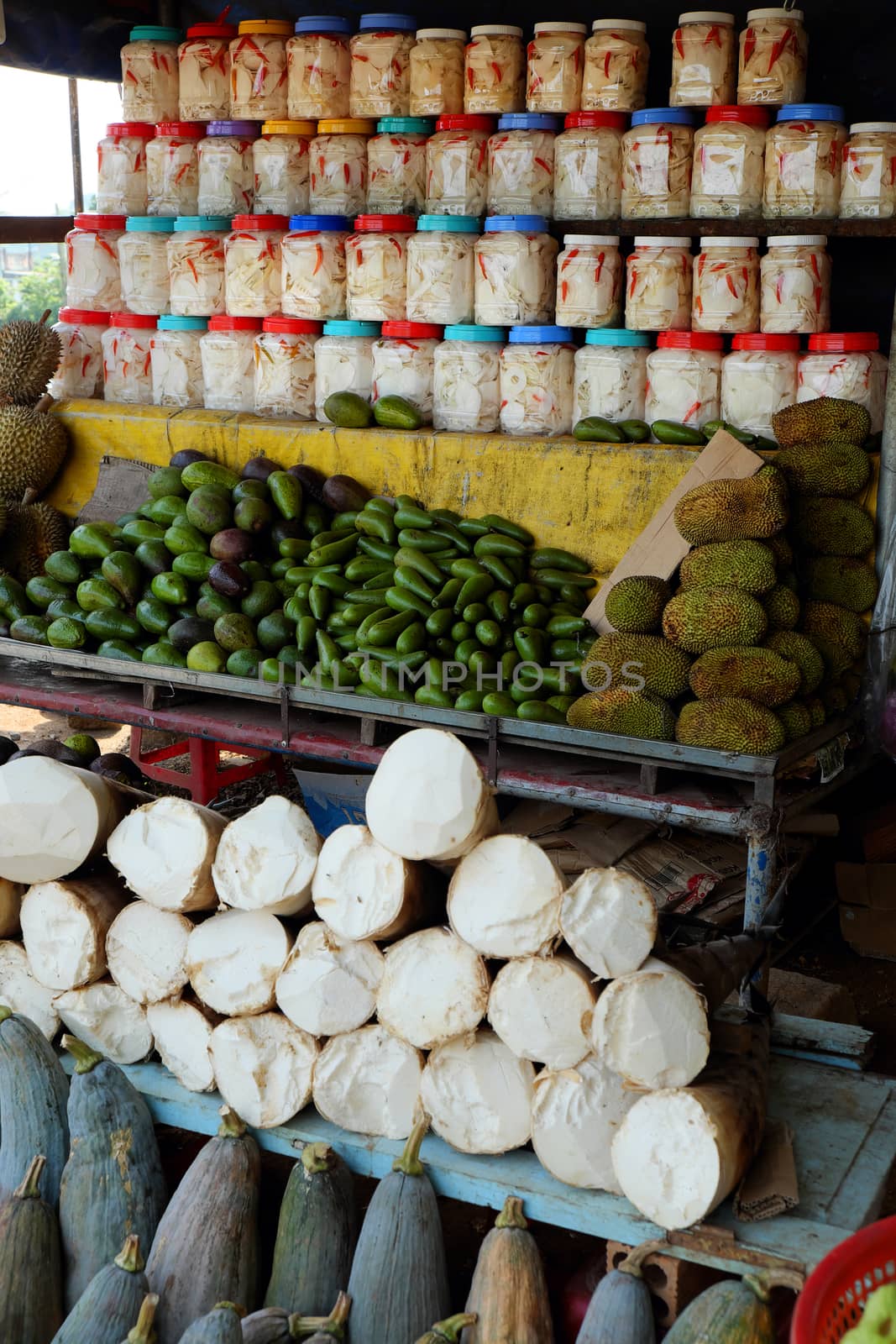 Group of Vietnamese fruit, vegetable show on shelf at outdoor farmer market, food store at roadside on highway, popular fruit as durian,  avocado, jackfruit and bamboo shoot, pumpkin