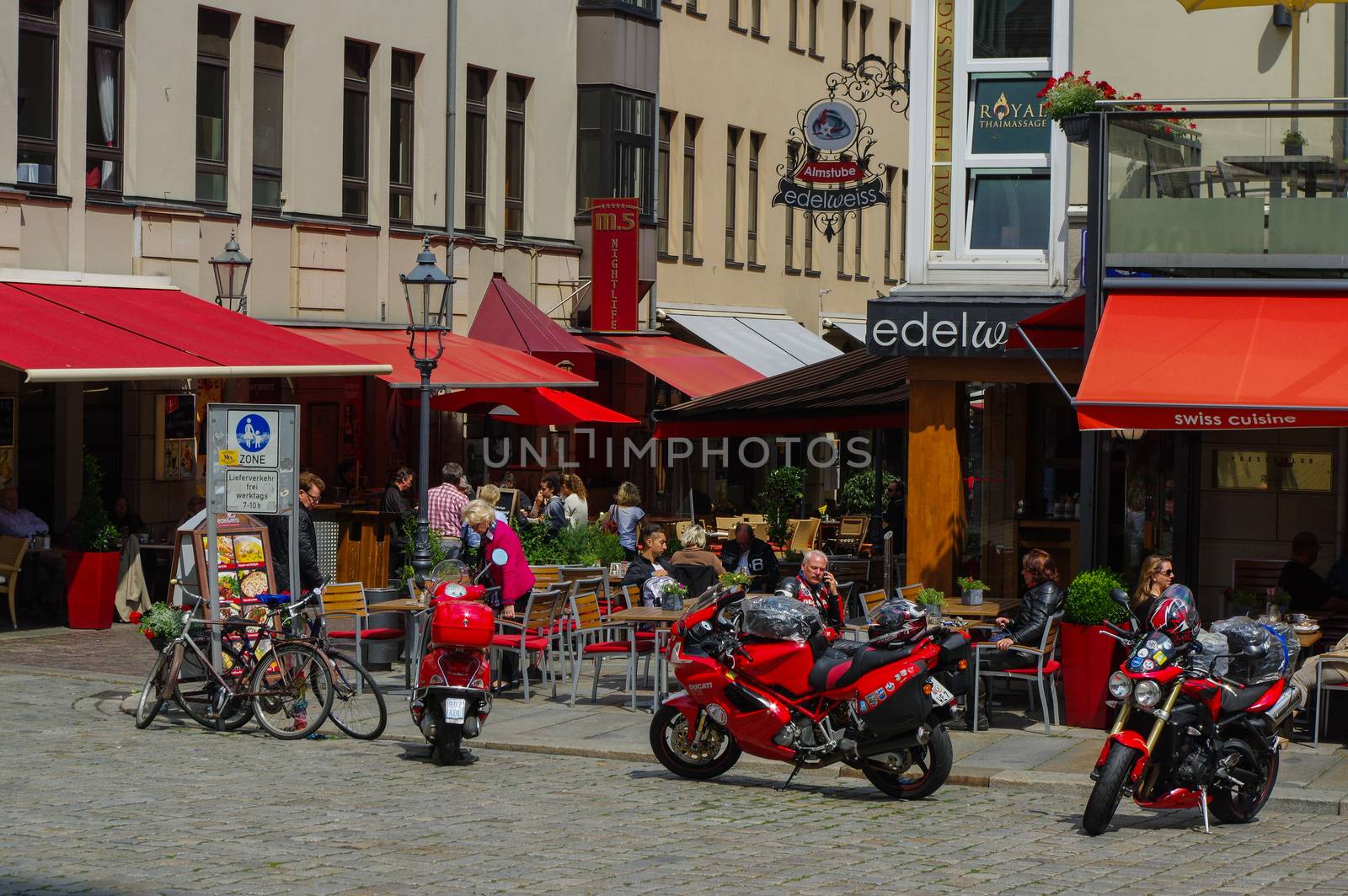 DRESDEN, GERMANY - SEPTEMBER 21, 2013: motorbikes in the cobblestone alley, is lined with many of Dresdens most famous restaurants and cafes. by evolutionnow
