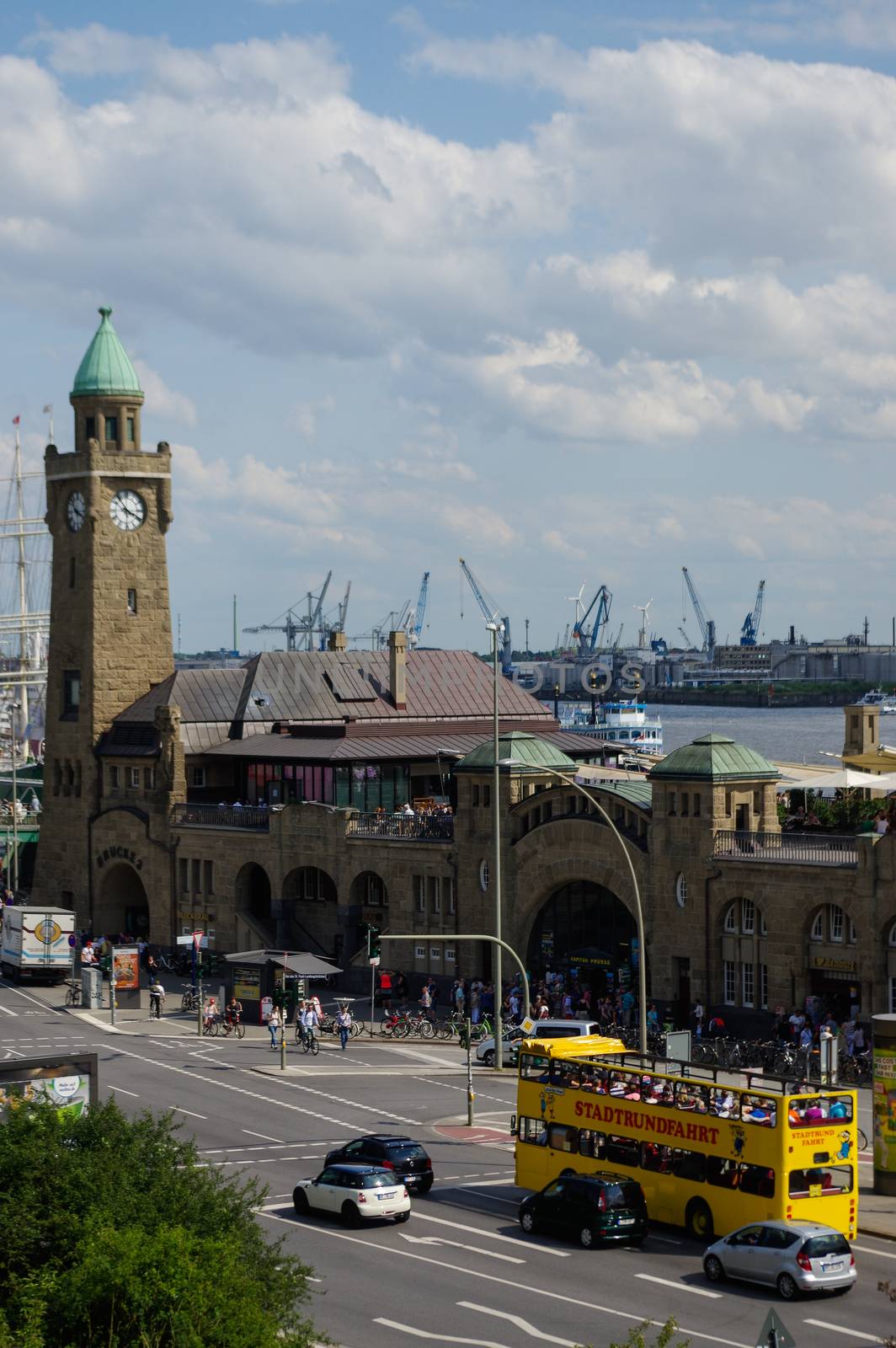 HAMBURG, GERMANY - JULY 18, 2016: a Beautiful view of famous Landungsbruecken with commercial harbor and Elbe river with blue sky and clouds in summer, St. Pauli district, Hamburg, Germany