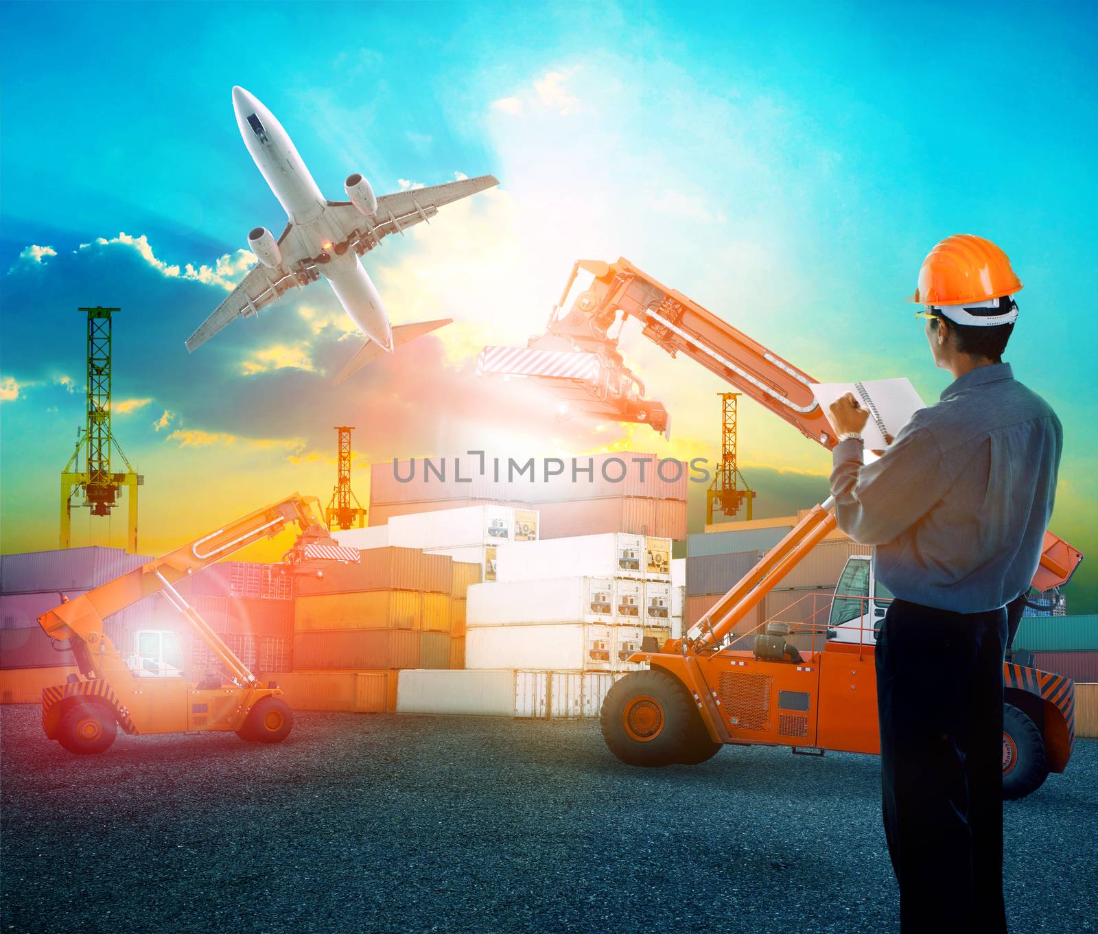 working man in logistic business working in container shipping yard with dusky sky and jet plane cargo flying above use for land to air transport and freight