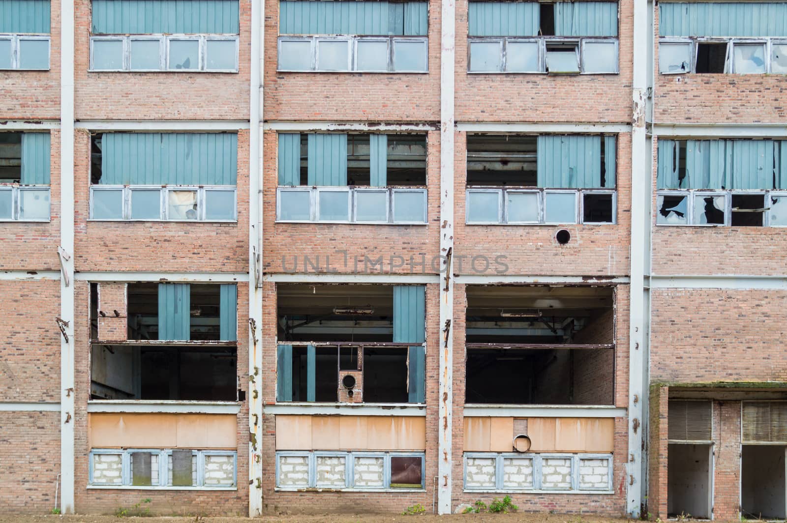 discarded ruin with old windows and wall, industrial window in concrete wall