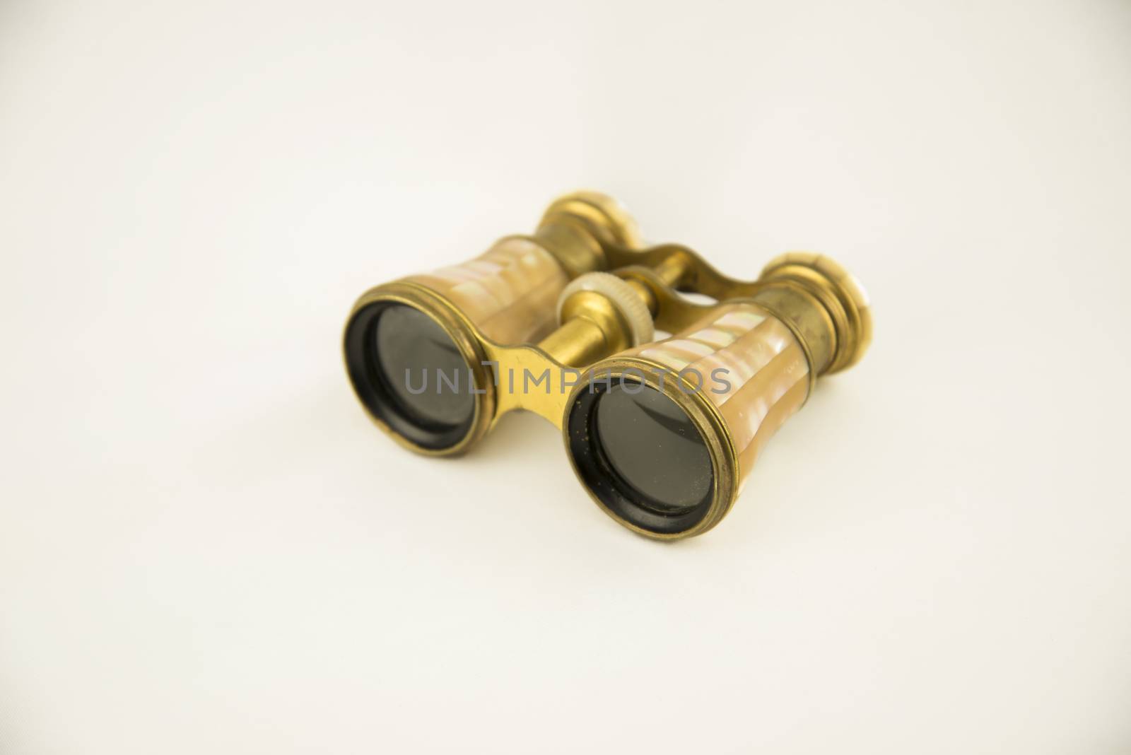Old opera binoculars isolated on a white background by edella