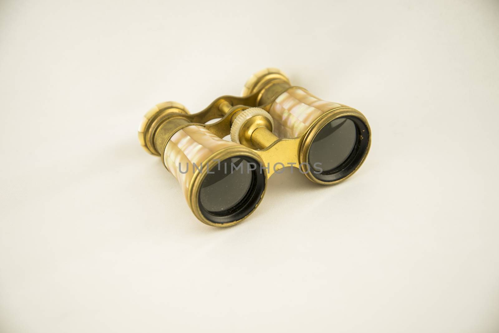 Old opera binoculars isolated on a white background by edella