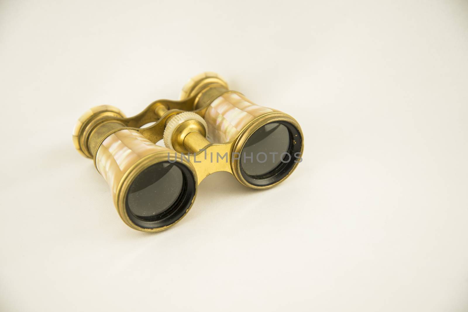Old opera binoculars isolated on a white background by edella