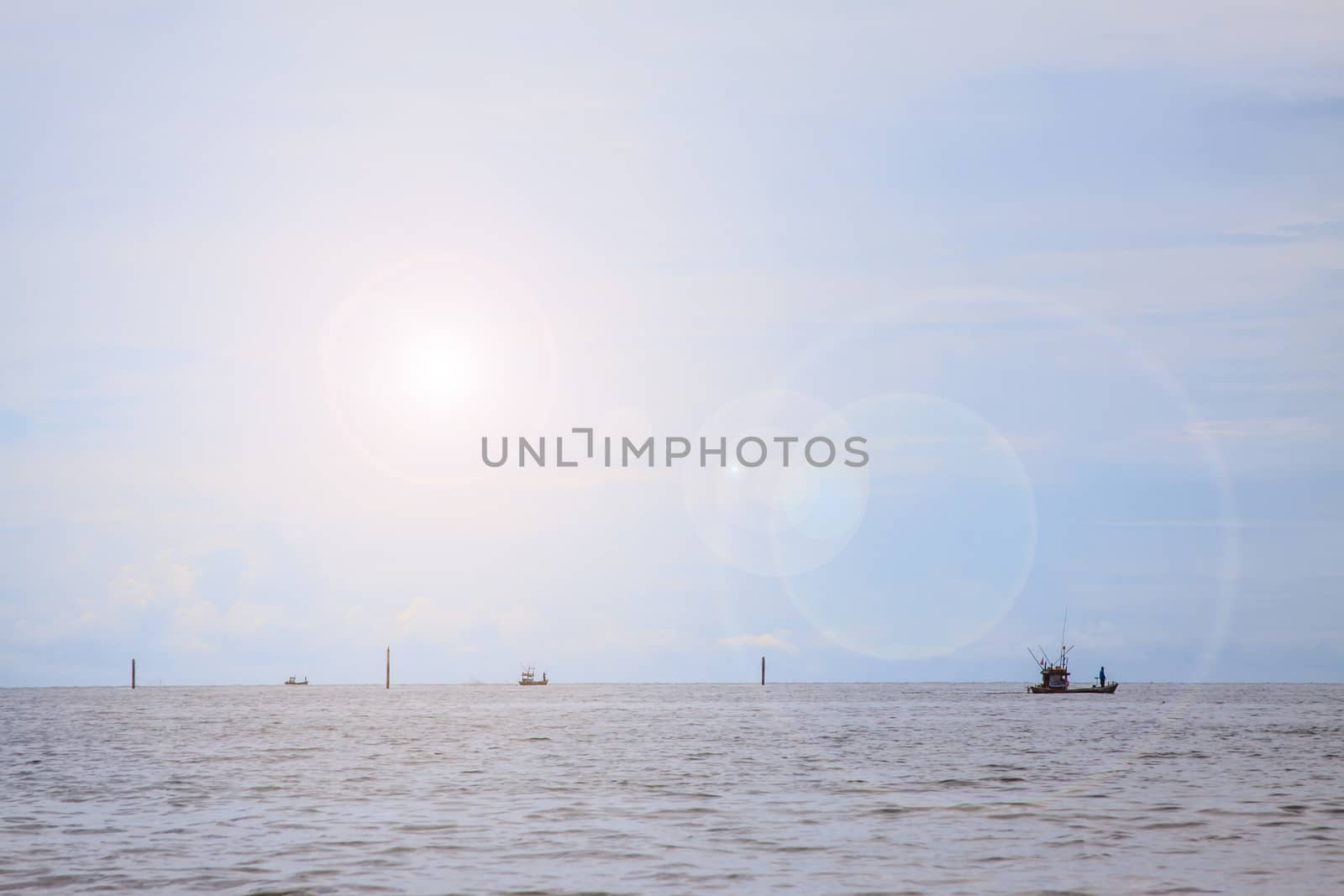 Fisherman and the sun with the sea background by worrayuth
