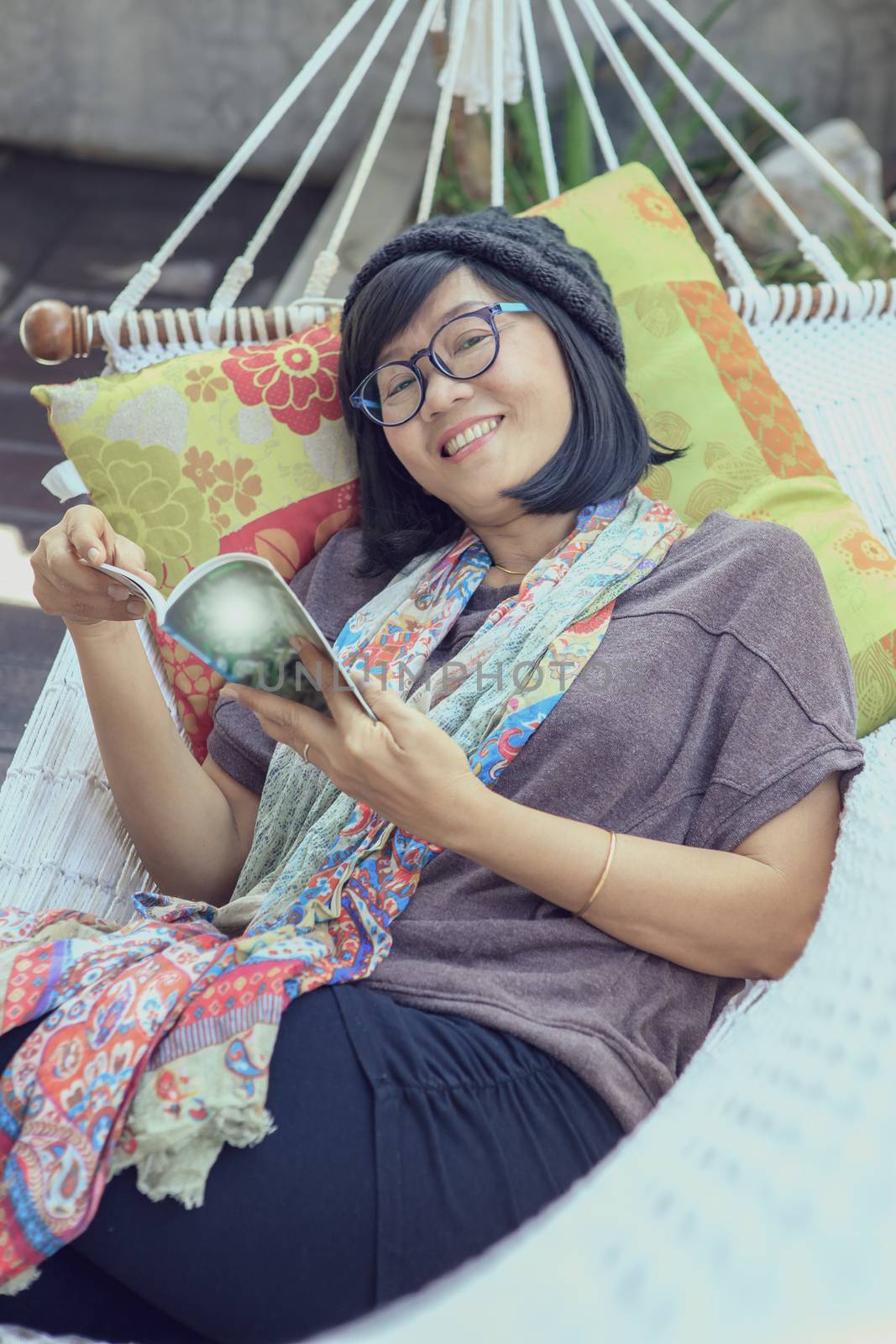 portrait of beautiful asian woman relaxing time reading book on cradle happiness emotion with smiling face