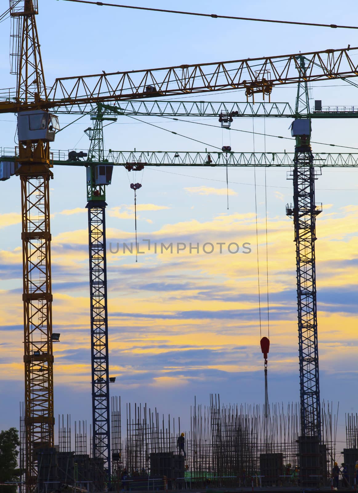 crane of building construction against beautiful dusky sky use for construction industry business and land development