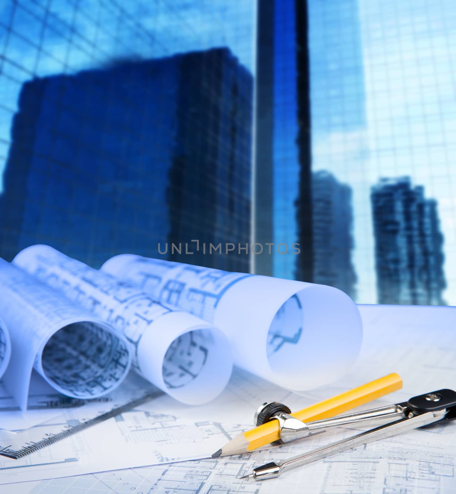 compass pencil blue print and office building in background use for construction theme