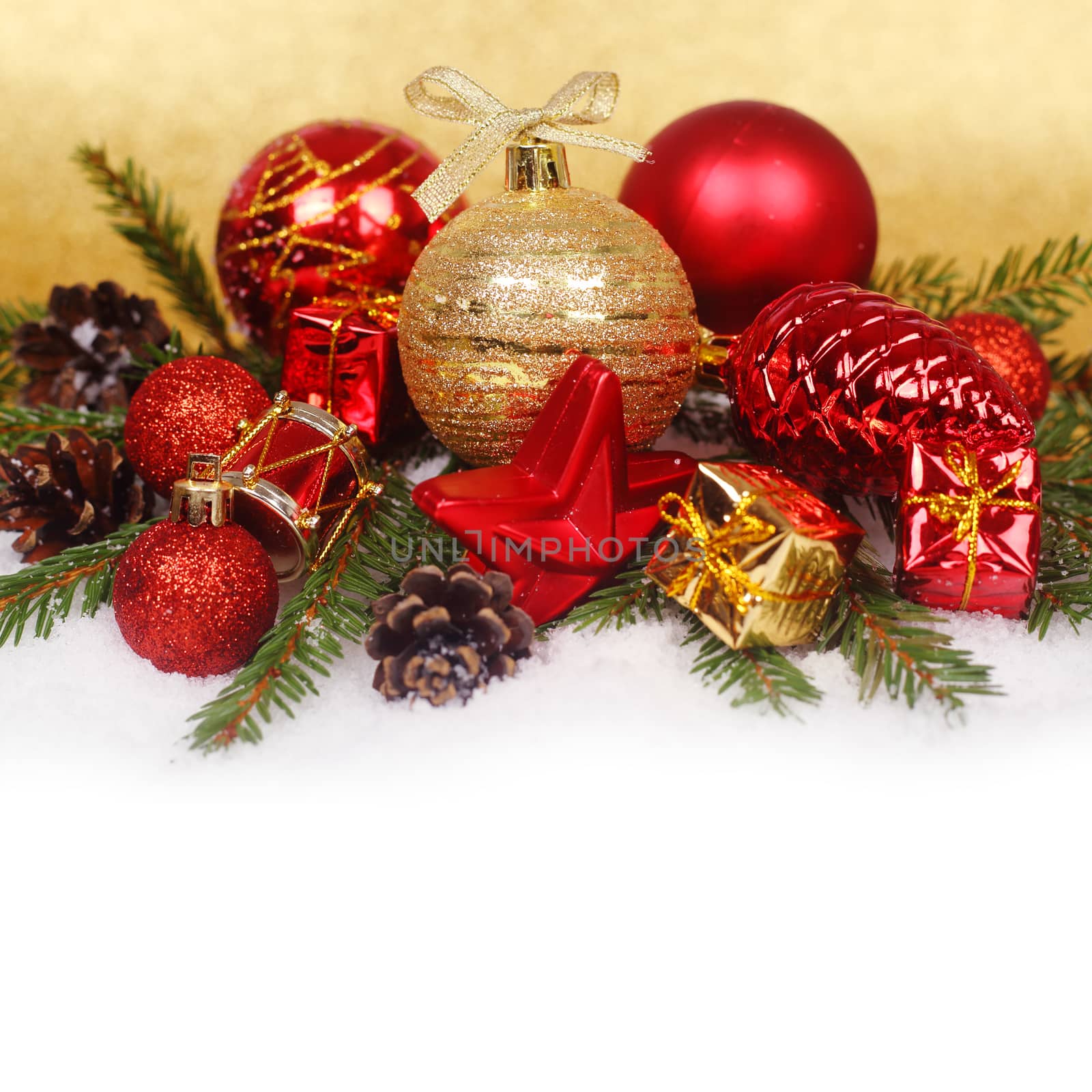 Christmas card with red baubles and gifts on golden bokeh light background with copyspace