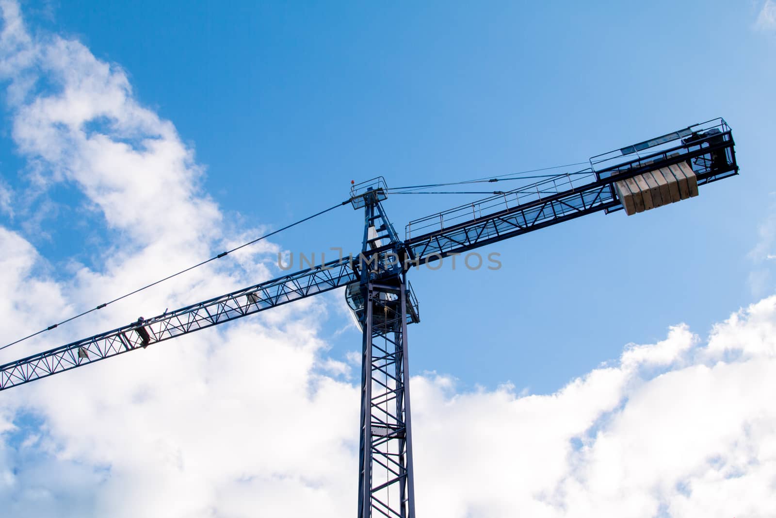 Construction site with cranes on sky background