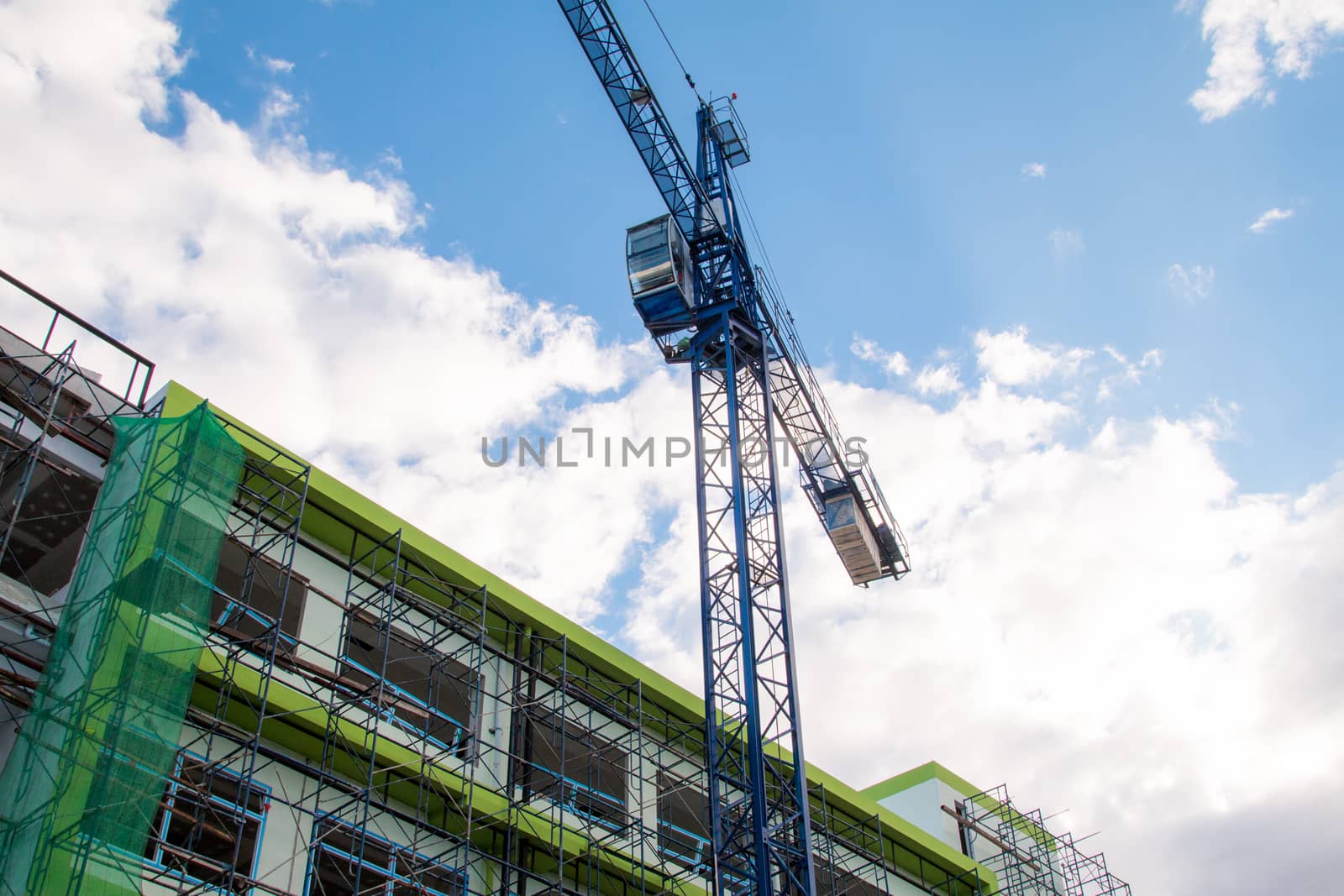 Construction site with cranes on sky background