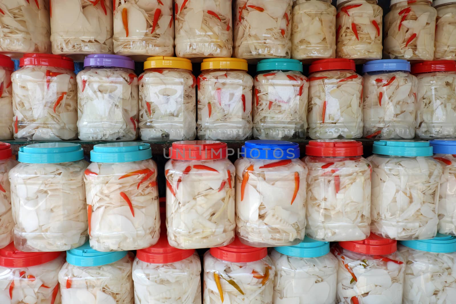 Vietnamese food in rainy season, bamboo shoot show on food store at marketplace, agriculture product process and keep in plastic jar