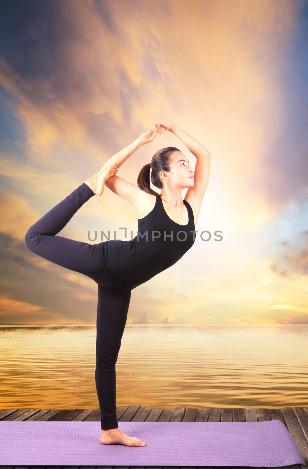 portrait of beautiful asian younger woman posting yoga for healt by khunaspix