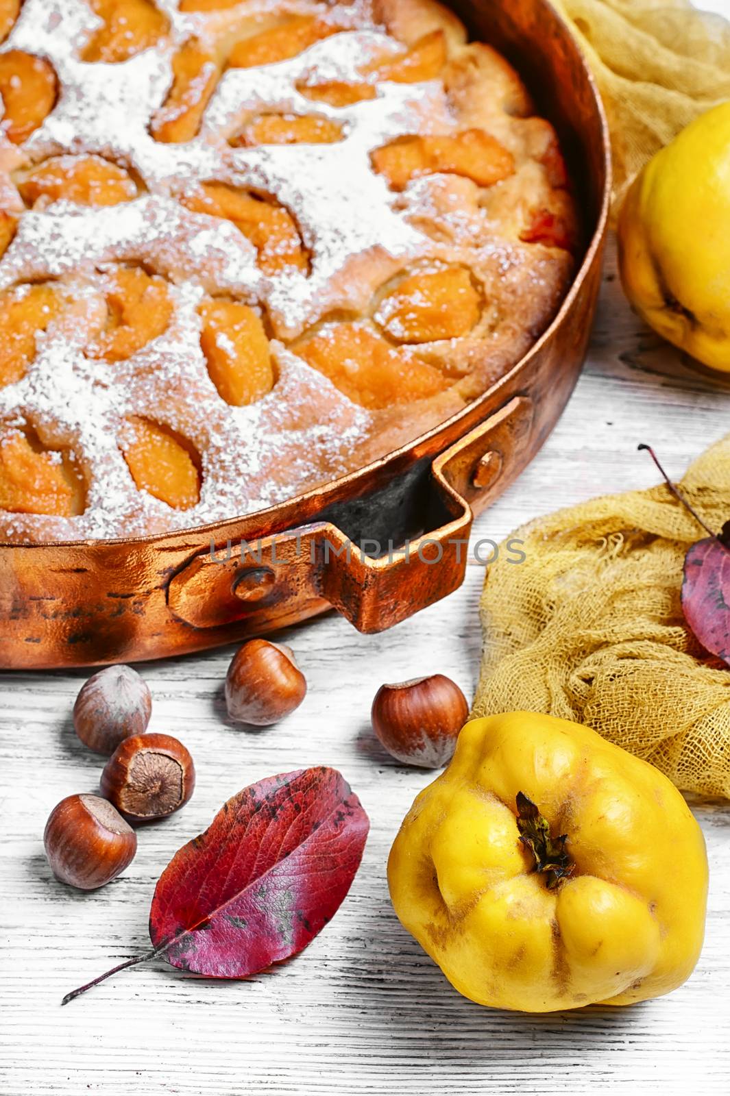 Baked pie with quince in copper kitchen form