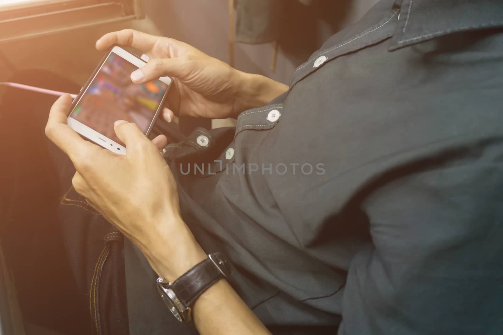 Asian business men holding and using smart phone screen.