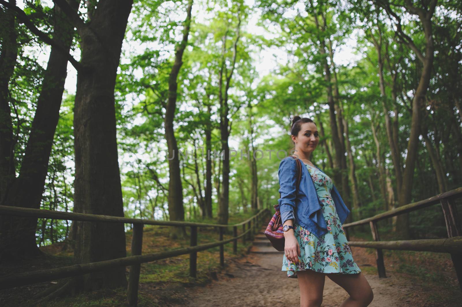 Young girl on a walk in the forest.