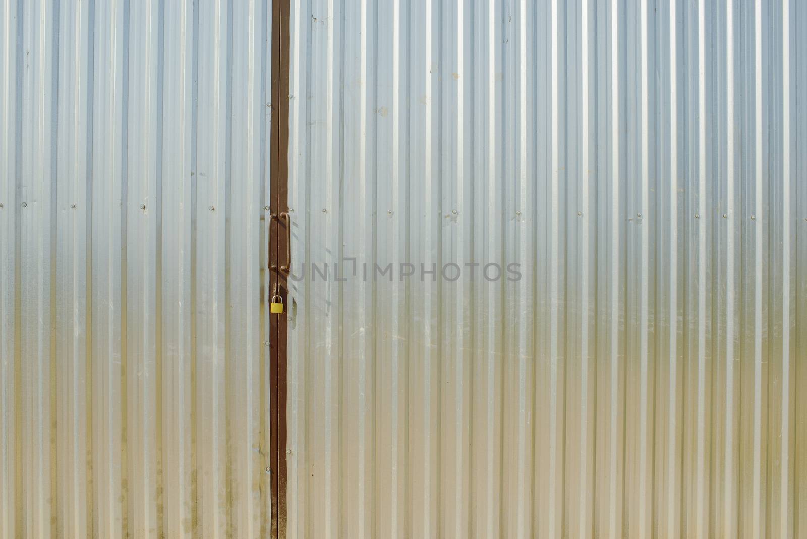 steel metal gray gate locked with padlock
