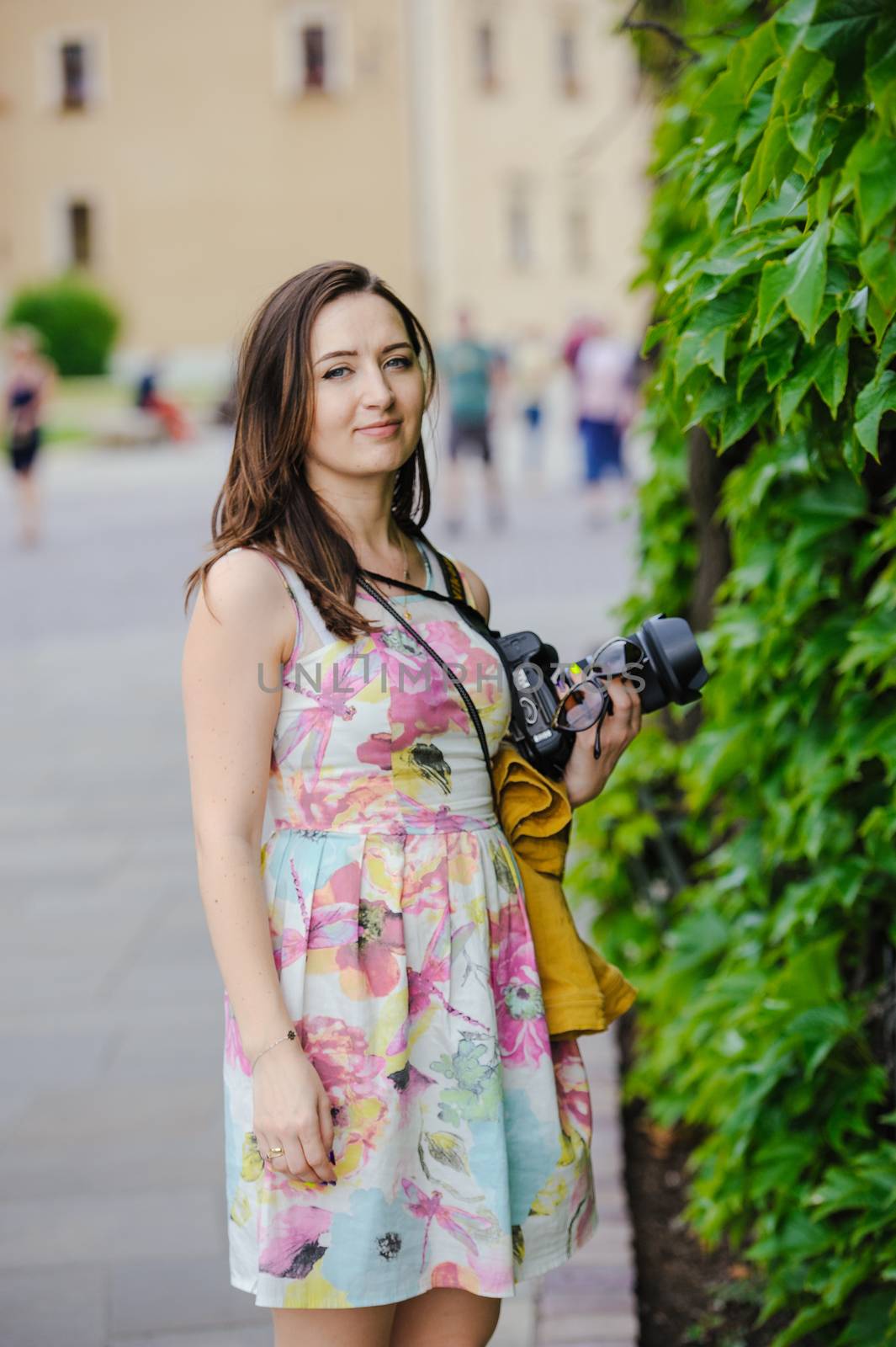 Female tourist takes picture in historic city in Cracow, Poland.