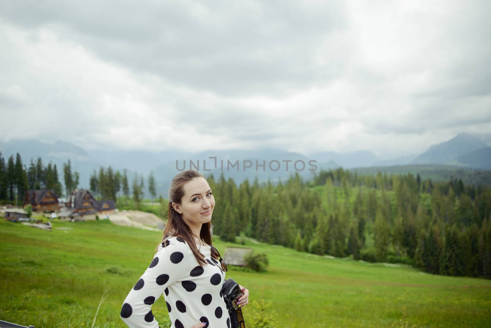brunette woman hiker hiking on trail in summer time. Tatra mountain in Poland.