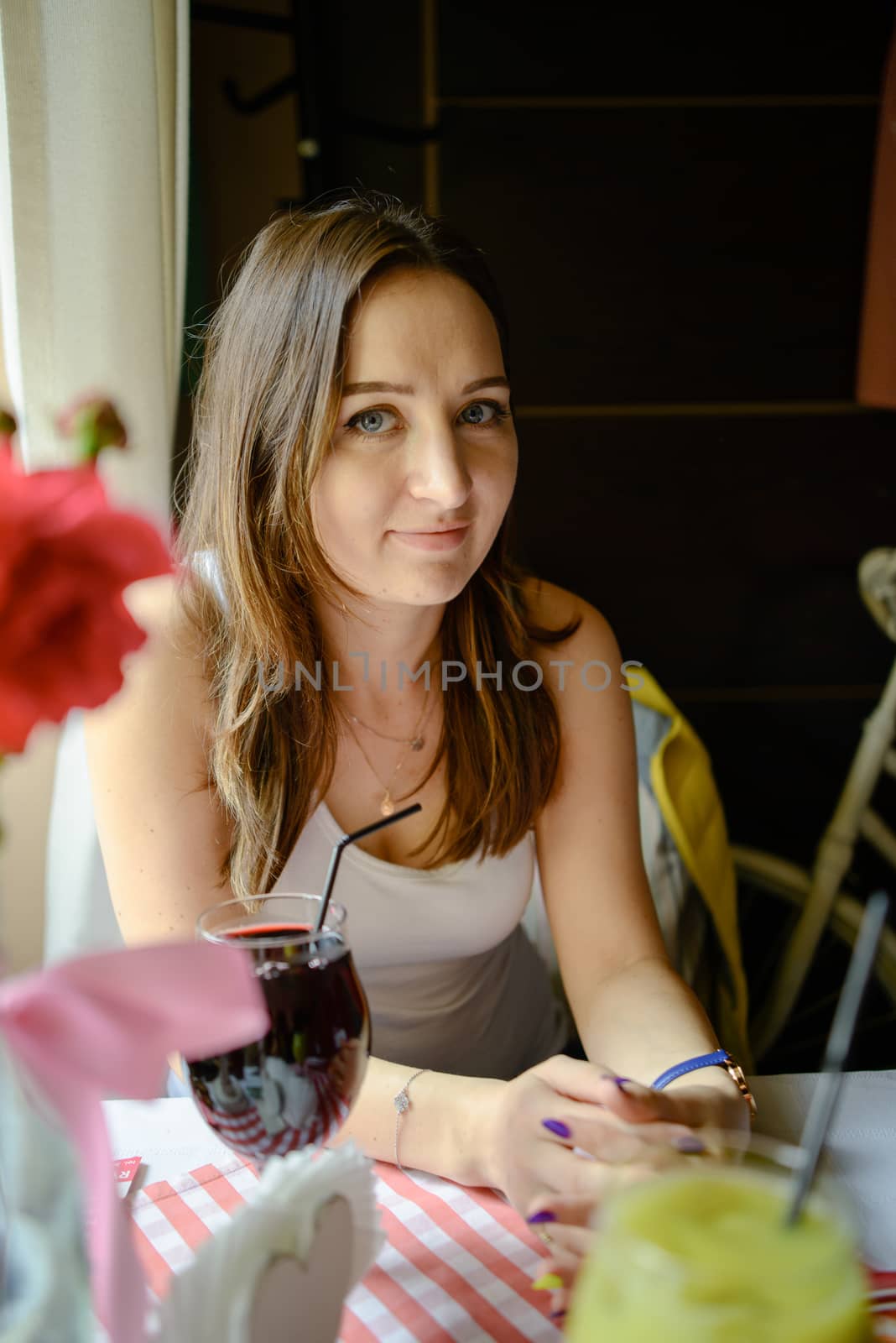 Woman Drinking Fresh Fruit Juice in restaurant