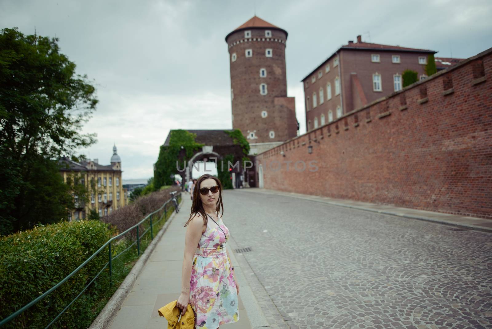 Beautiful girl during sightseeing old castle in Cracow, Wawel. Summer time