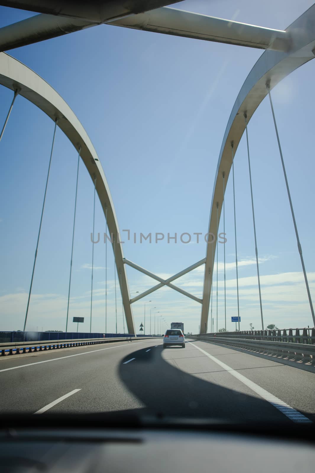 Car view over the steel bridge in summer day
