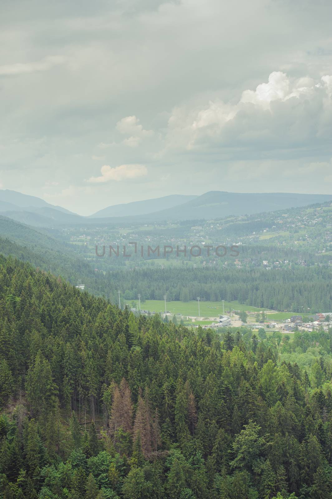 Mountains under mist in the morning and city in the valley. Tatra Mountain