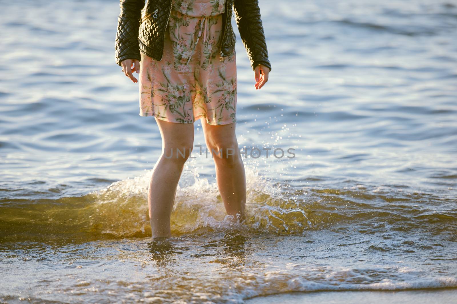 People walking on the beach in the ocean. Summer time