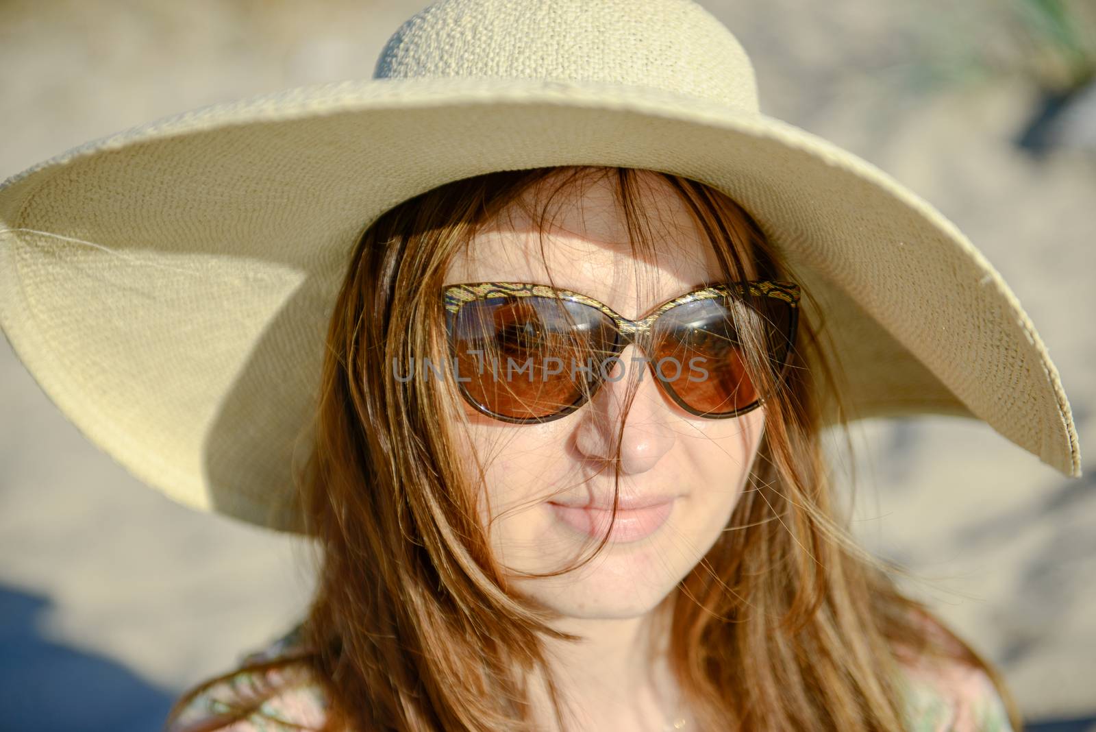 Young happy woman wearing dress on the beach. Summer time
