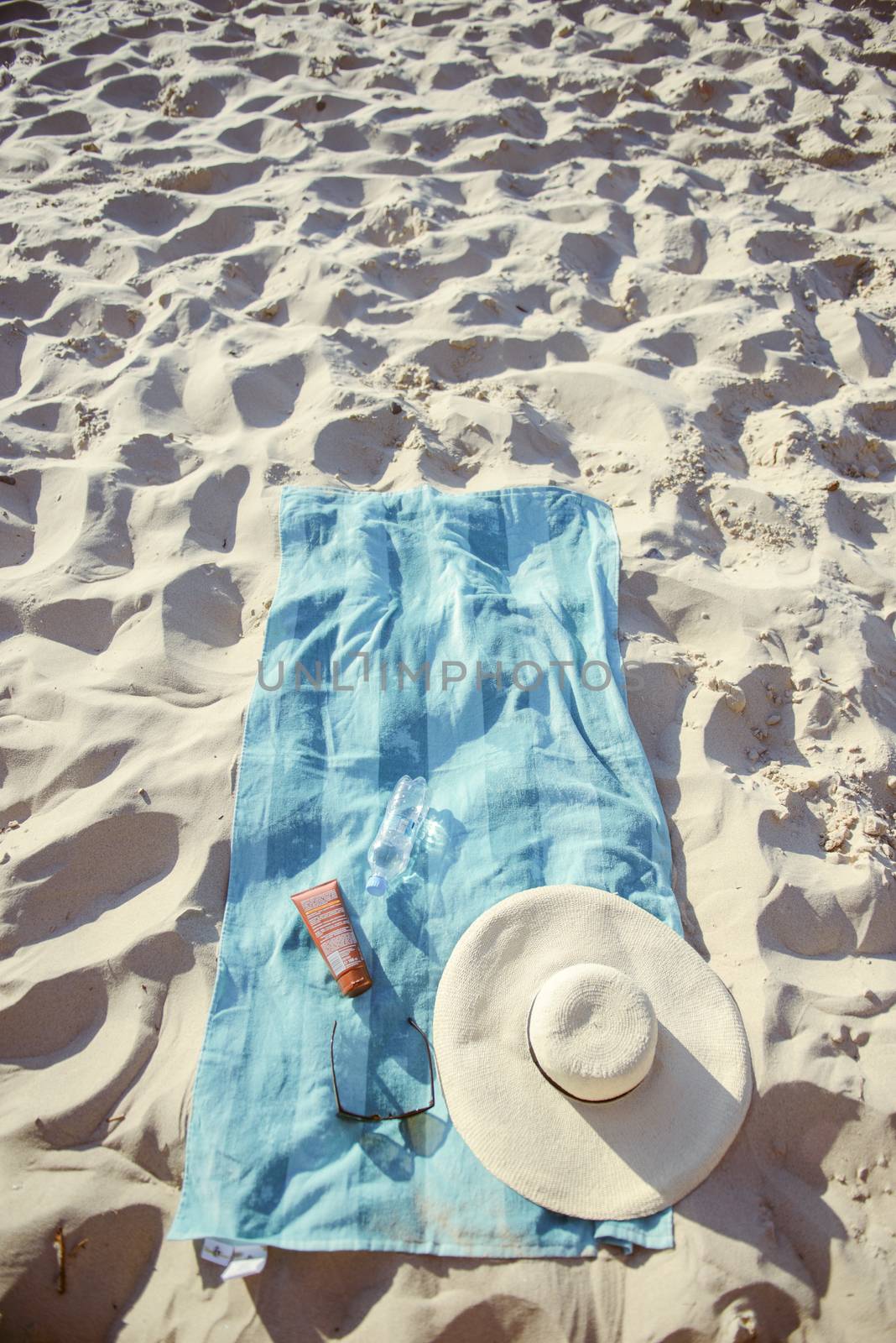 beach background with hat, towel and glasses