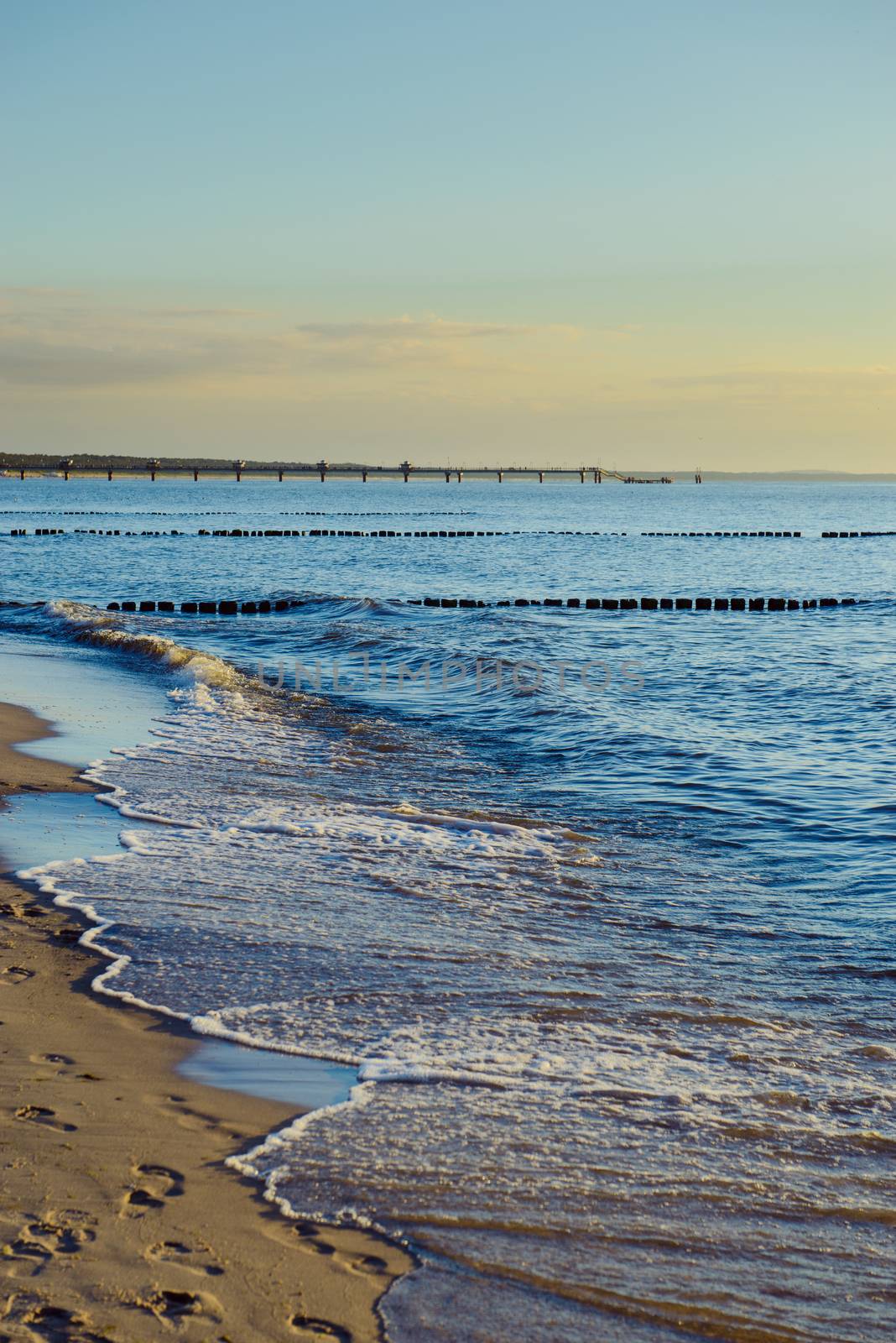 Breakwaters in the Baltic sea over the sunset in summer