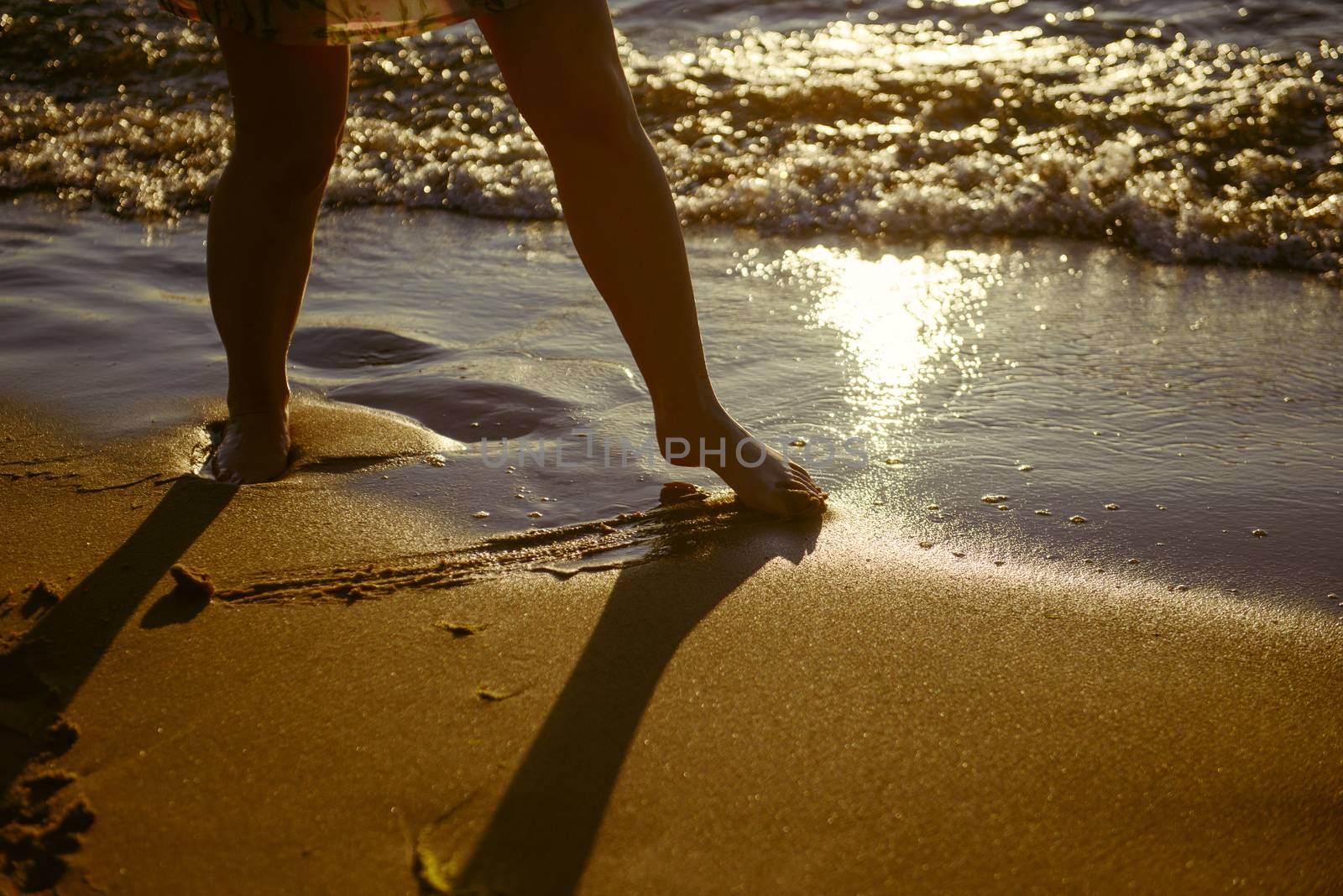 Vacation holidays. Feet closeup on beach on sunbed enjoying sun on sunny summer day.