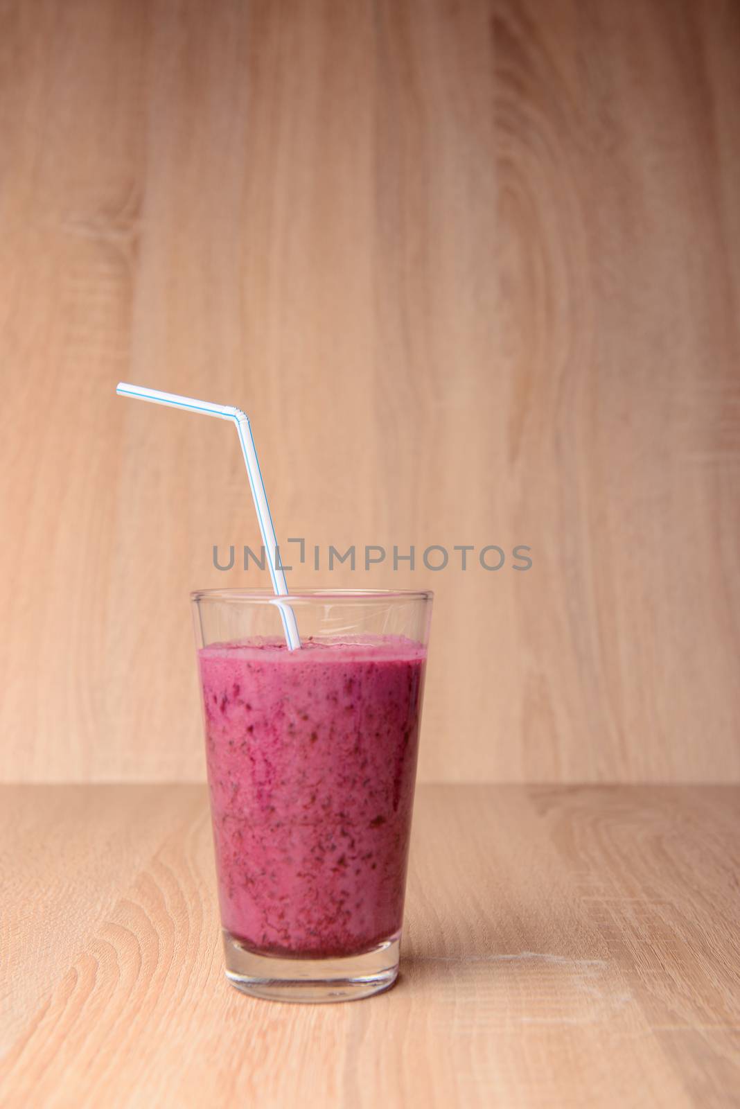 Blueberry smoothie with fresh berries, chia seeds and banana for breakfast on rustic wooden background, selective focus