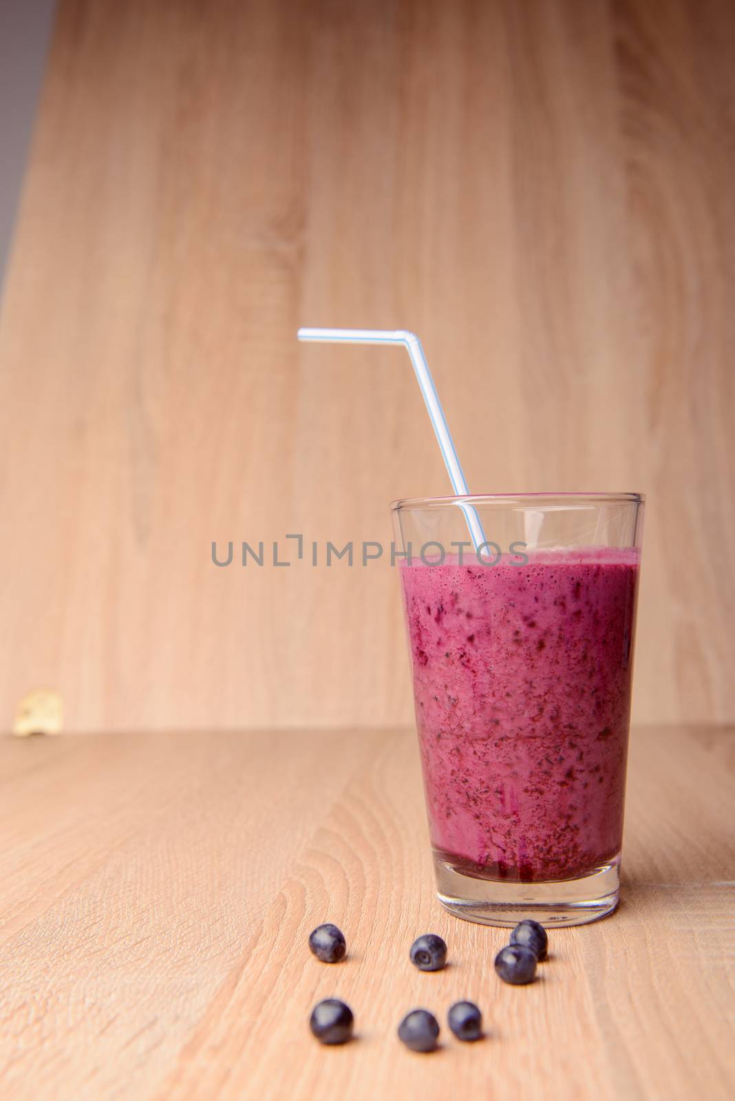 Blueberry smoothie with fresh berries, chia seeds and banana for breakfast on rustic wooden background, selective focus