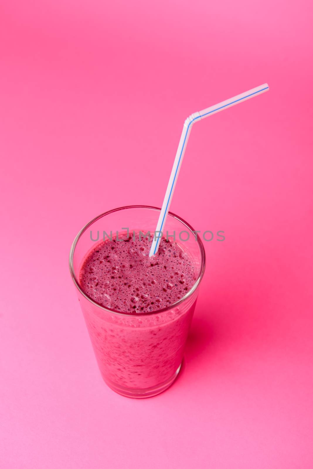 Blueberry smoothie with fresh berries, chia seeds and banana for breakfast on pink background, selective focus