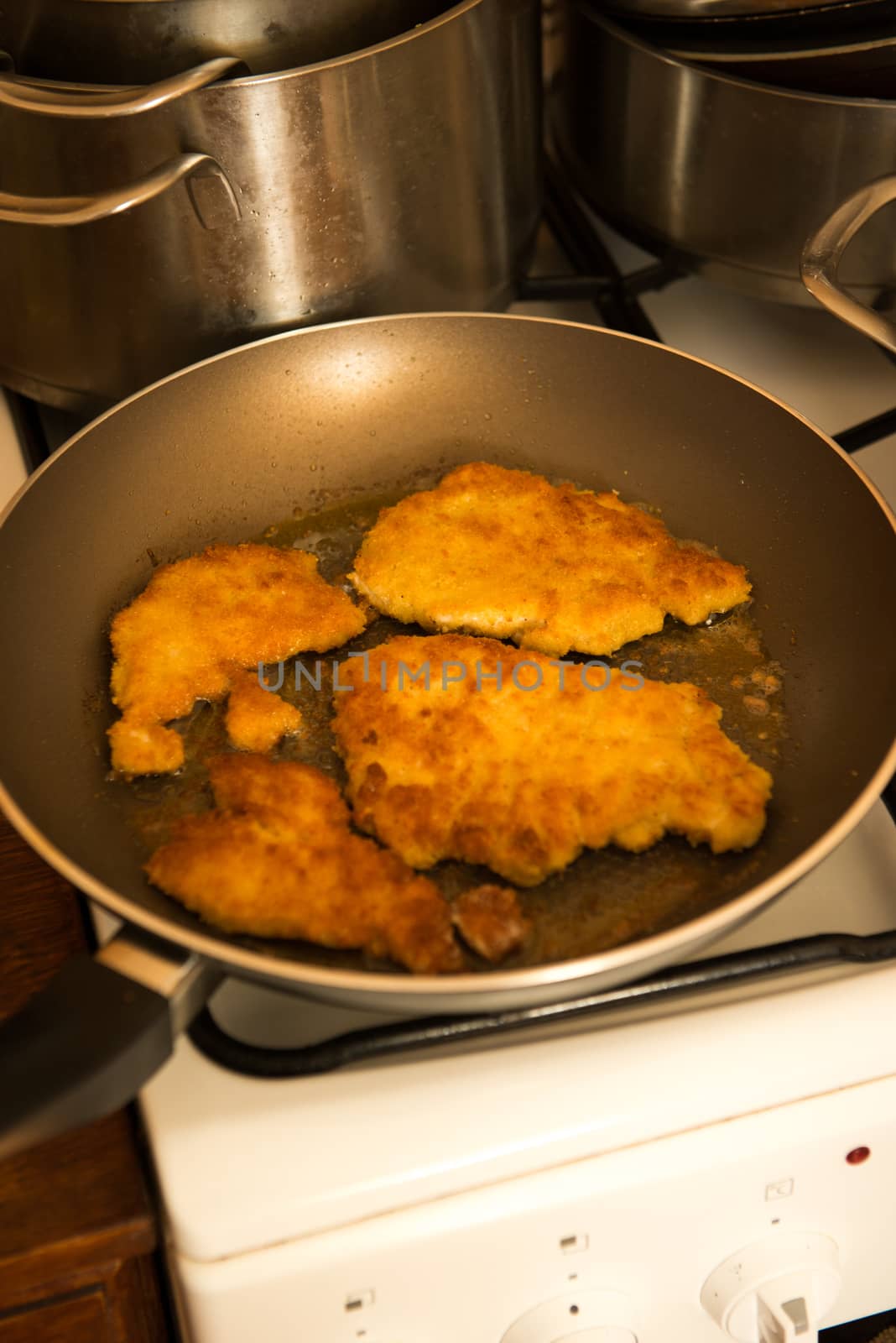 fried golden pork chops in the pan
