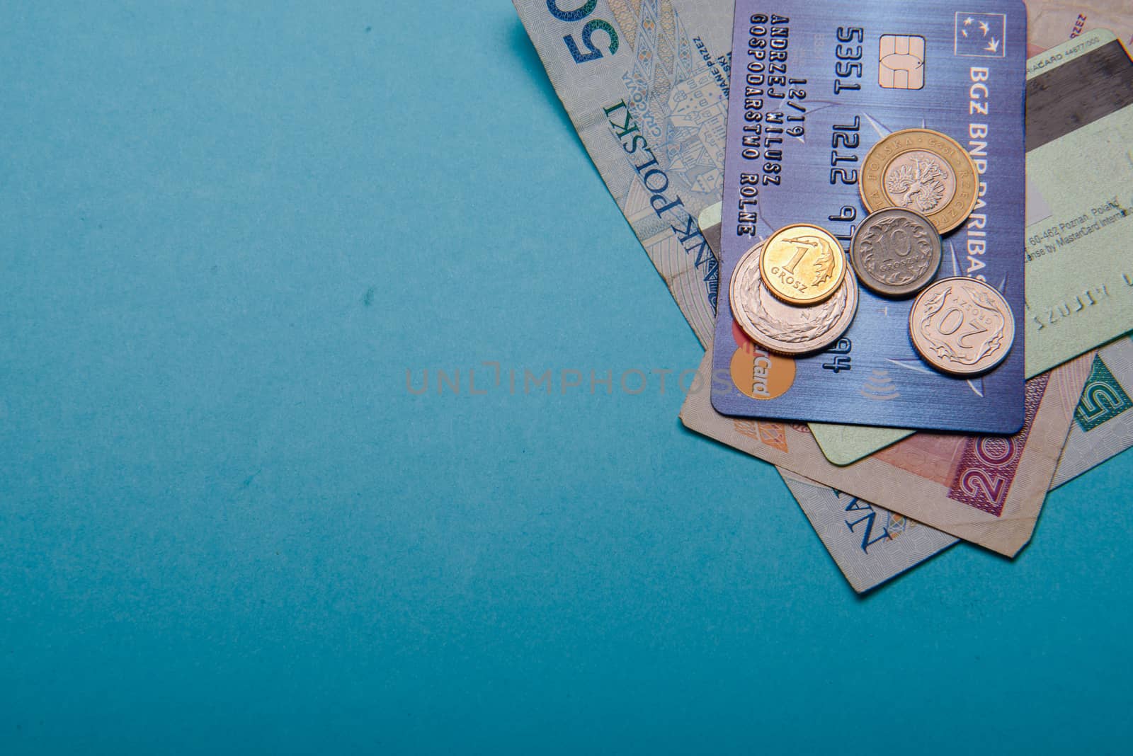Polish zloty in notes and coins on blue background