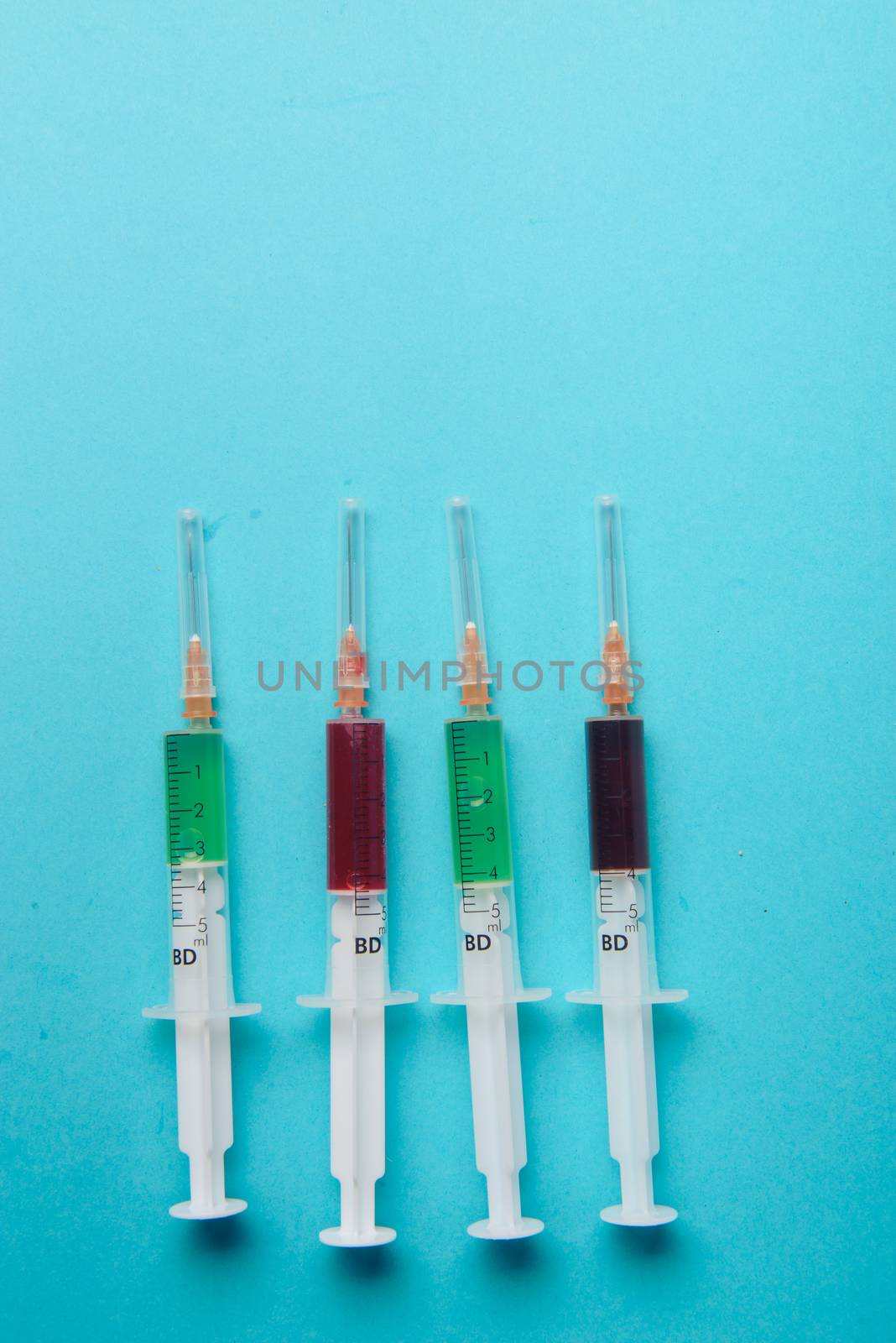 syringe on blue background. Injections. Food adittive