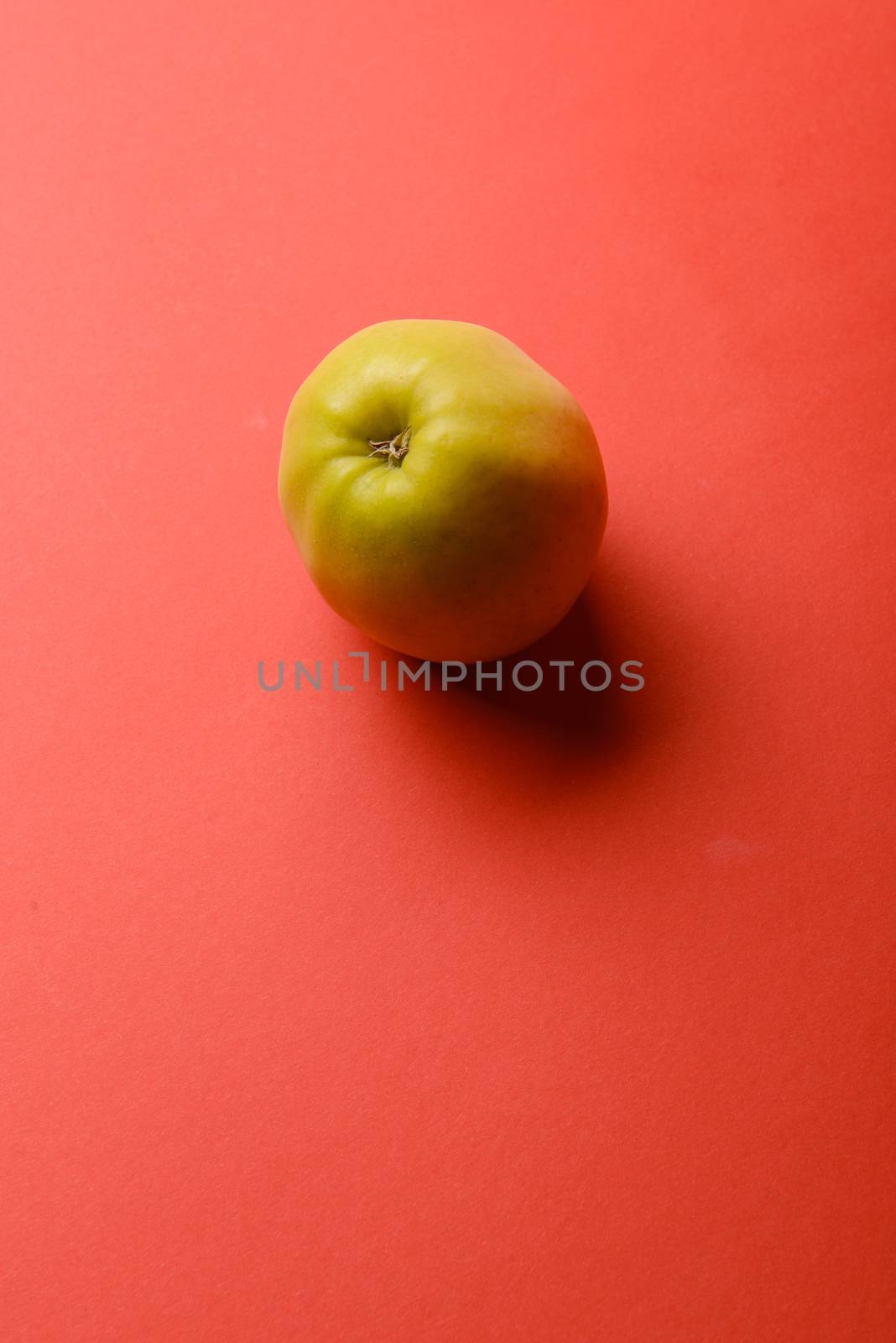 Delicious apple isolated on a red background background