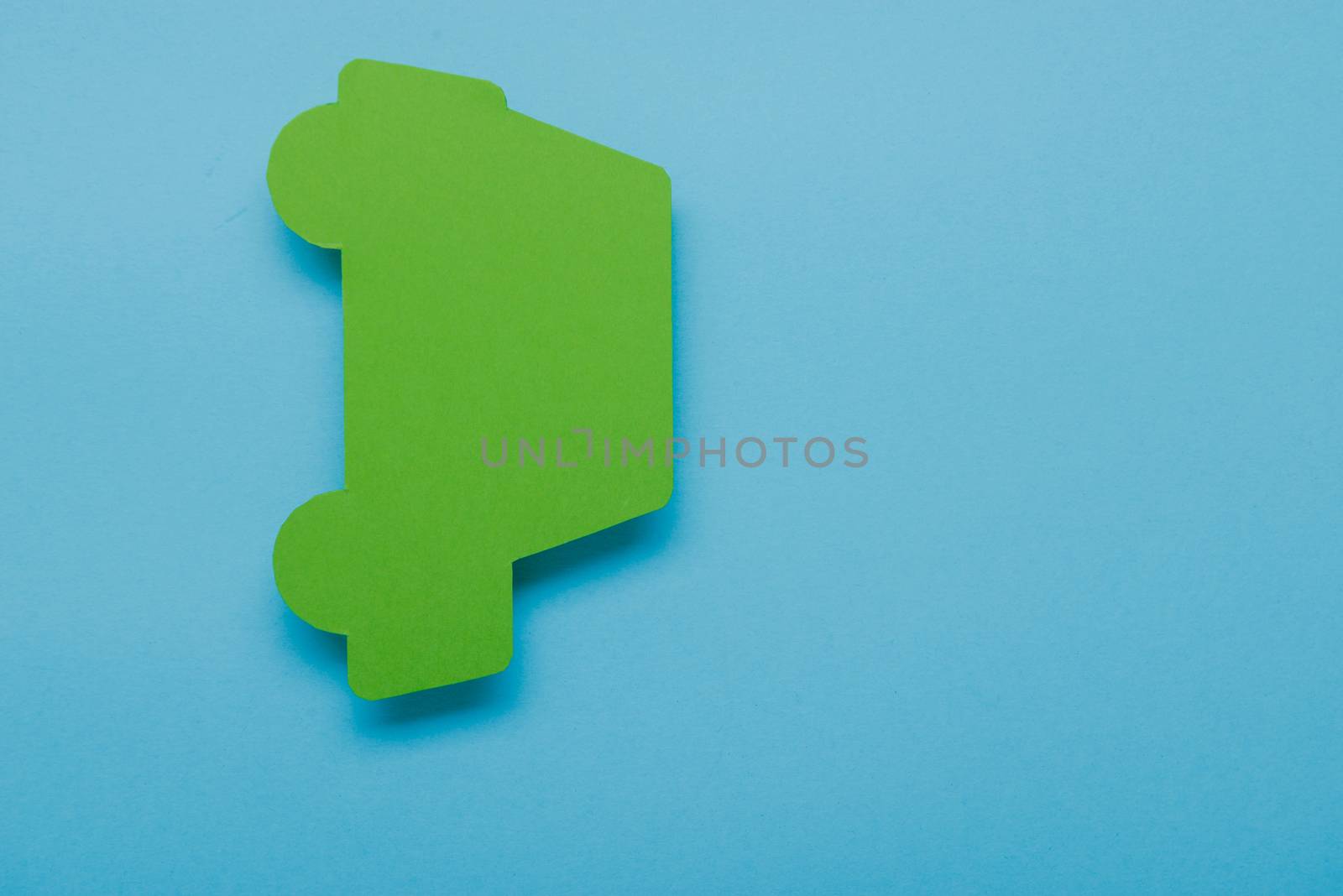 paper green cars figure. top view on blue background