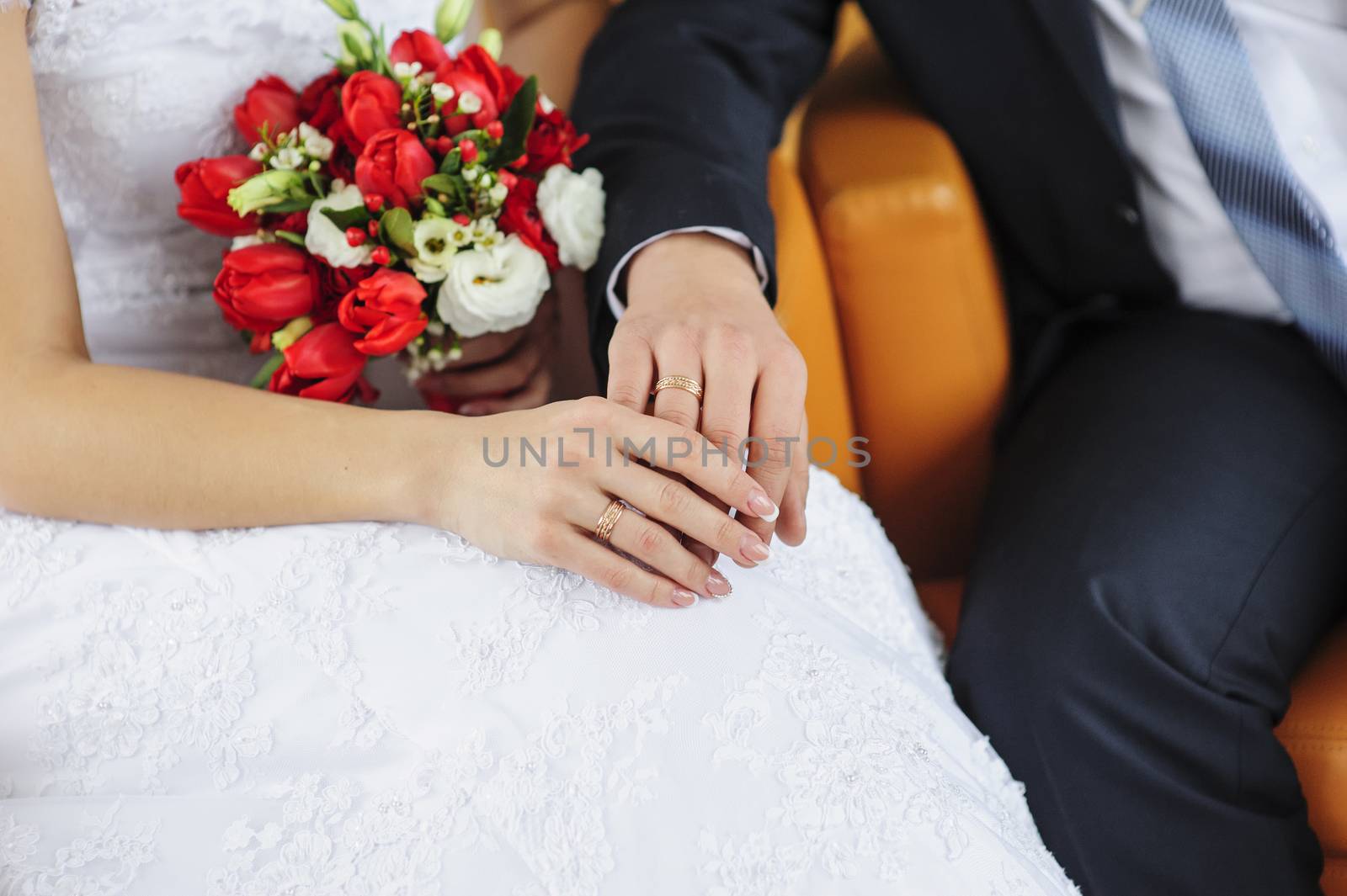 Hands and rings on wedding bouquet. wedding theme background 