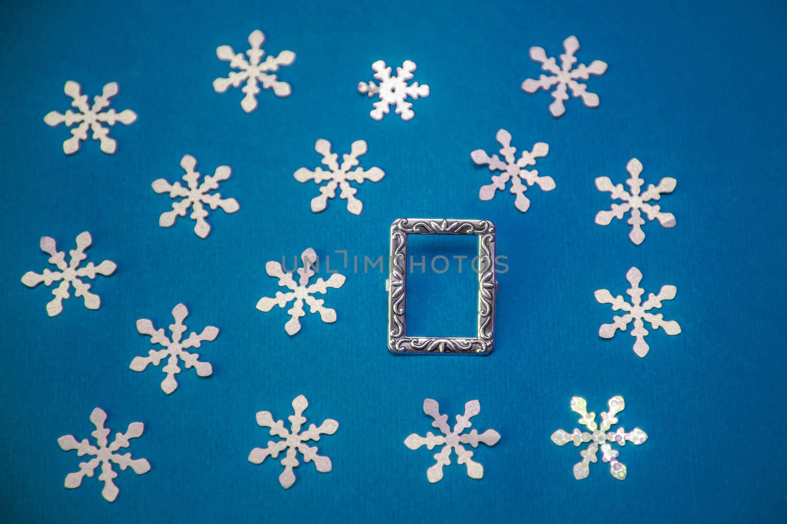 Christmas card with frame and snowflakes on a blue background