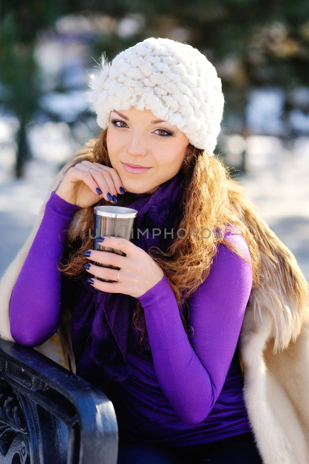 Beautiful winter woman have fun in winter park throwing snowflak by timonko