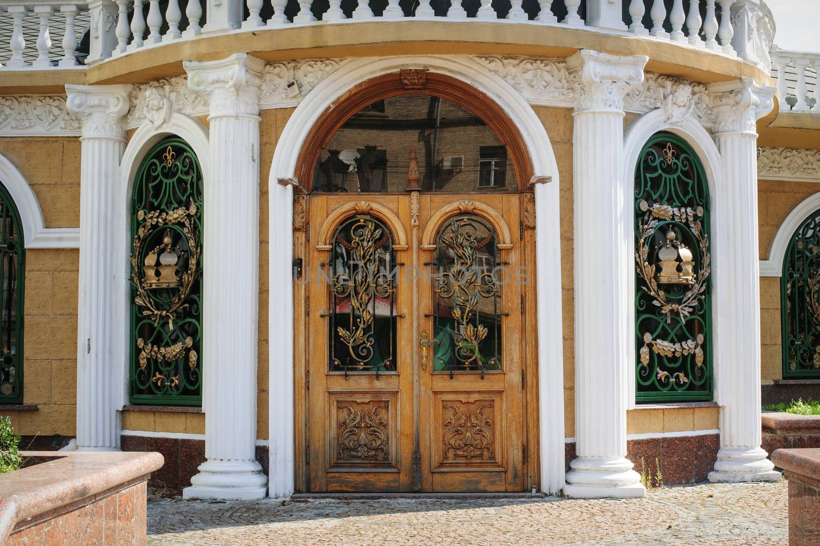 wooden door with forged metal grate 